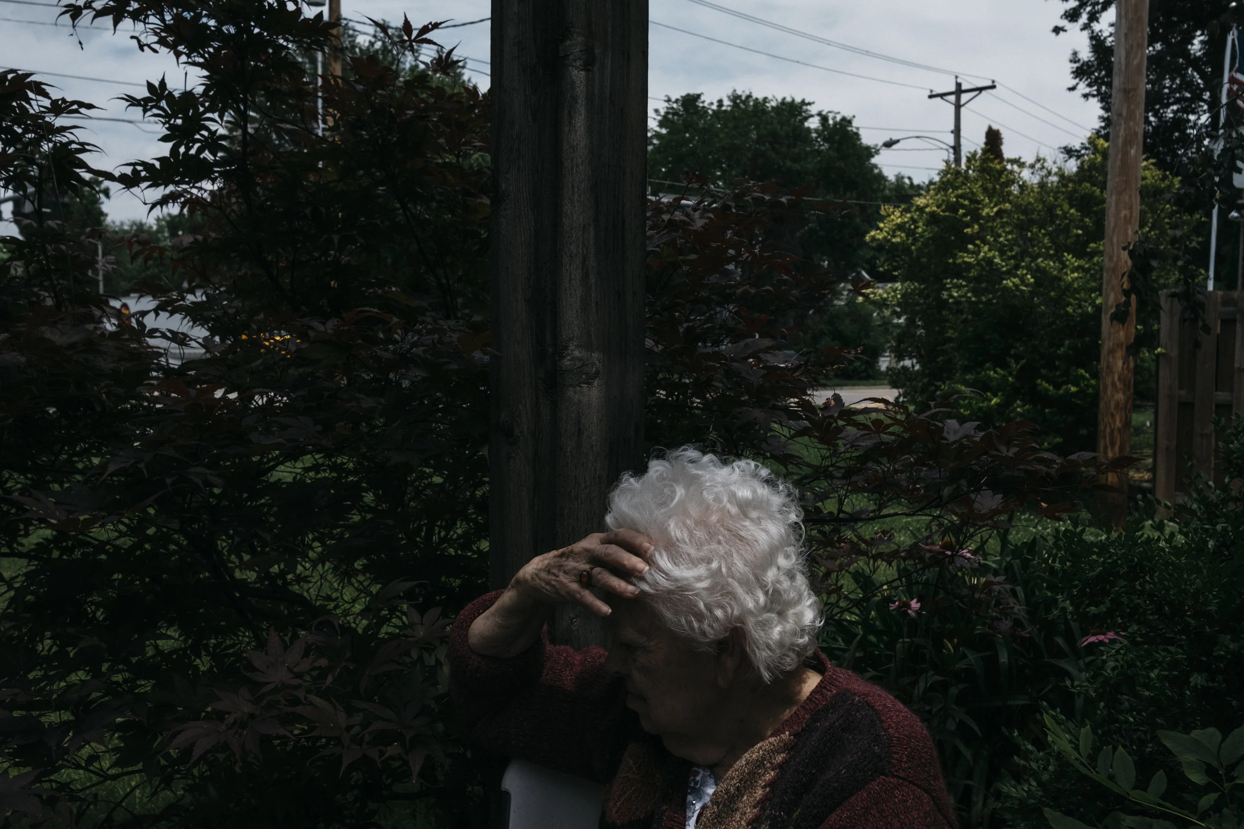  Mary Lou Enslen, 87, holds her hand over her face while waiting in the gazebo during a fire drill on Thursday, June 20, 2019 at King's Daughters Home in Mexico, Mo. Enslen has dementia. 