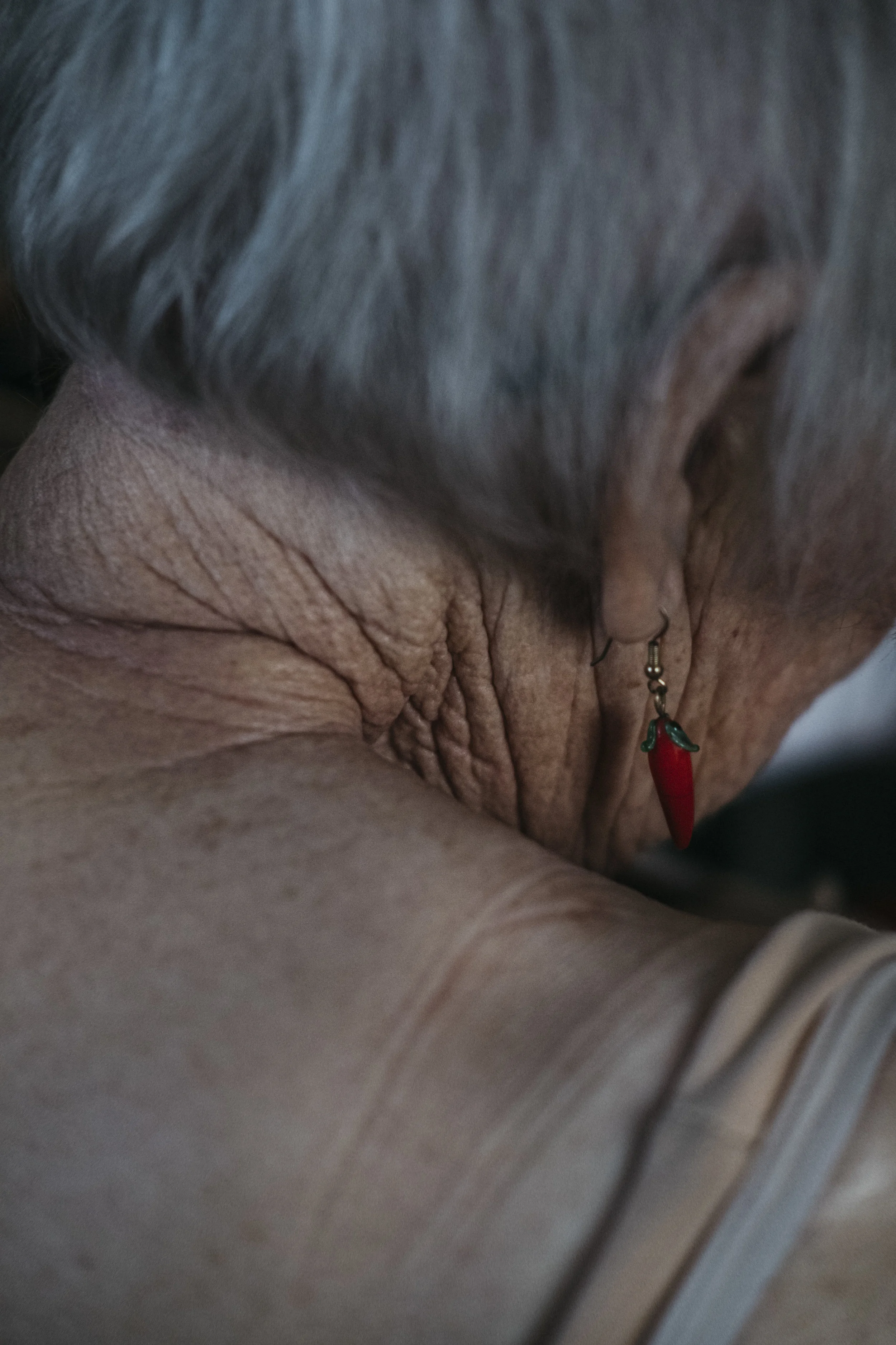  Onilee Crossland, 92, changes into her pajamas on Wednesday, June 19, 2019 at King's Daughters Home in Mexico, Mo. Crossland purchased her chili pepper earrings during a trip to Texas.   