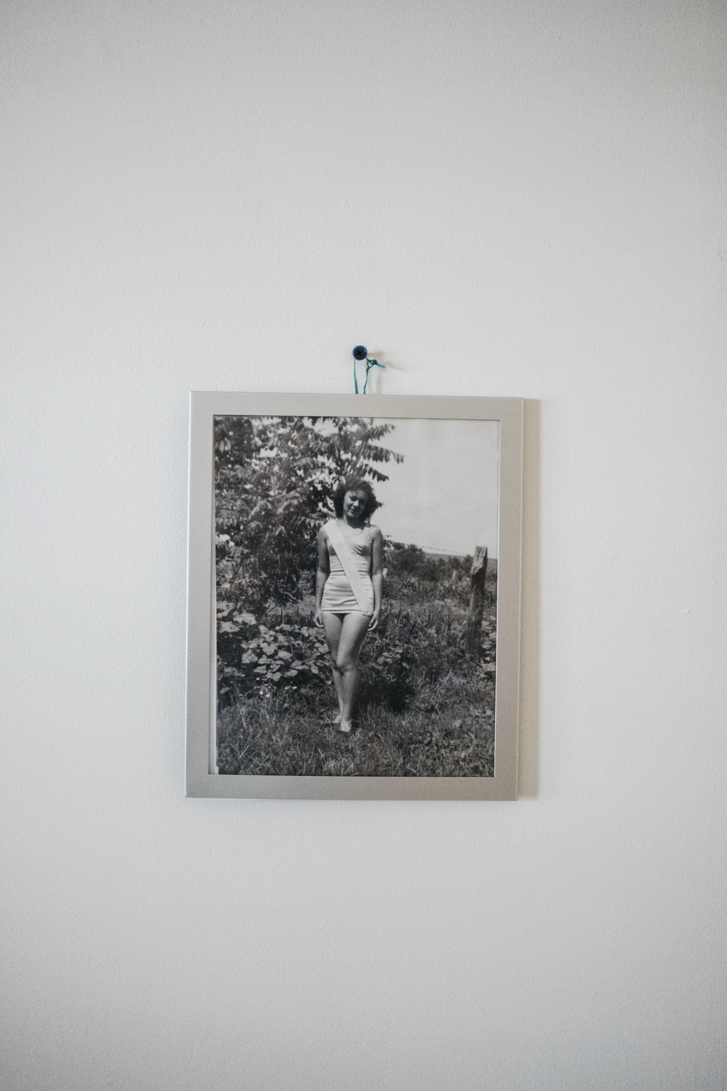  A photo of Mary Lou Enslen as 1949 Miss Auxvasse hangs above her bed at King's Daughters Home on Saturday, June 15, 2019 in Mexico, Mo. Mary Lou has dementia. 