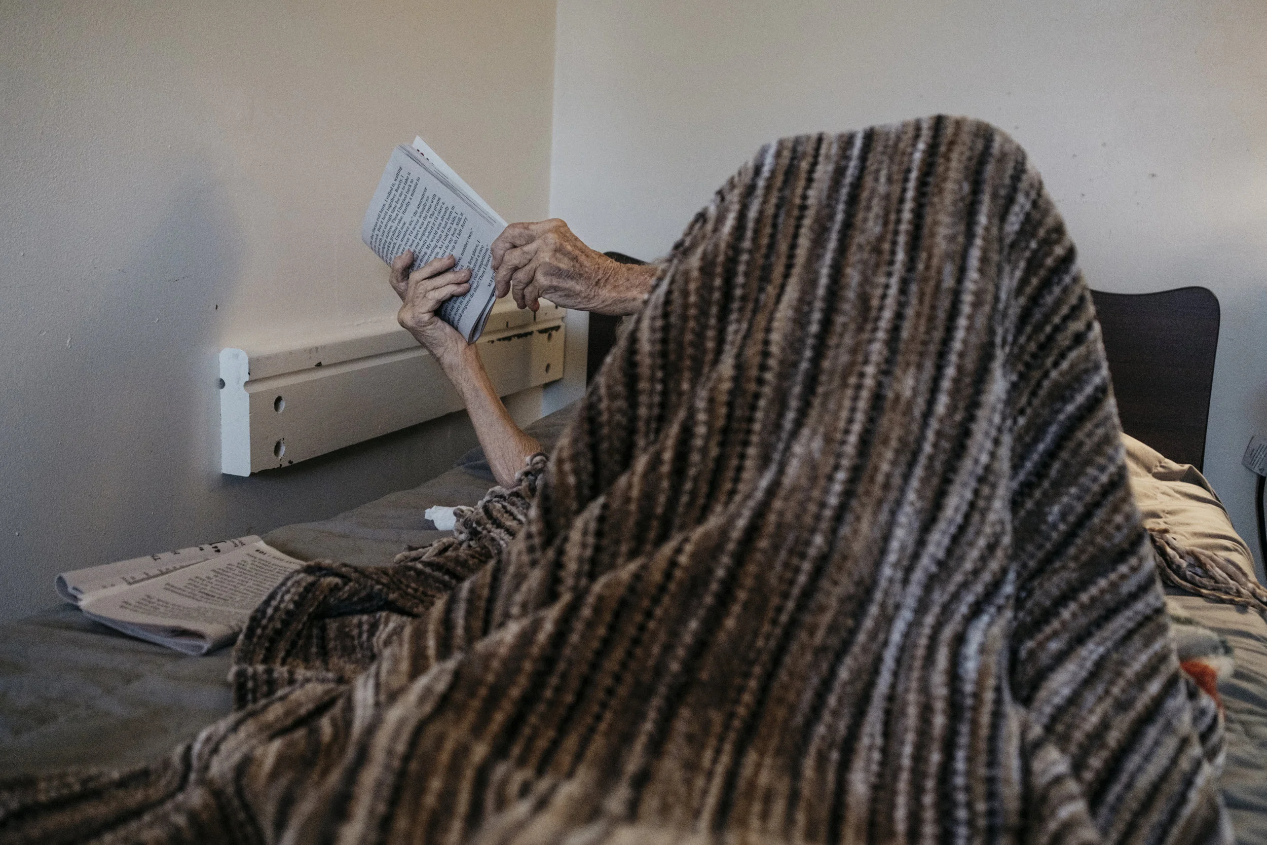  Ina Kahmke, 98, reads before bed on Wednesday, June 19, 2019 at King's Daughters Home in Mexico, Mo. 