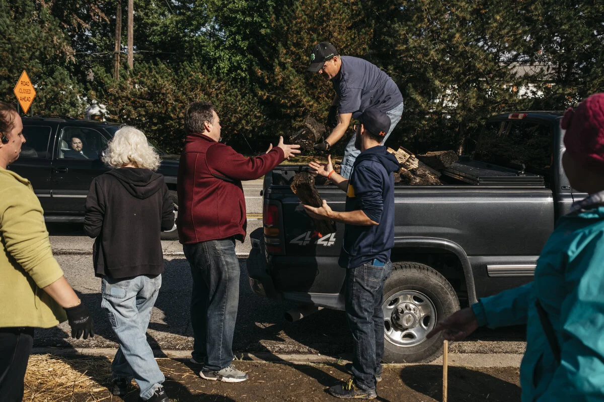  UAW members and supporters unload wood for the fire outside the General Motors Flint Assembly Plant during the 18th day of the strike on Thursday, Oct. 3, 2019 in Flint, Mich.  