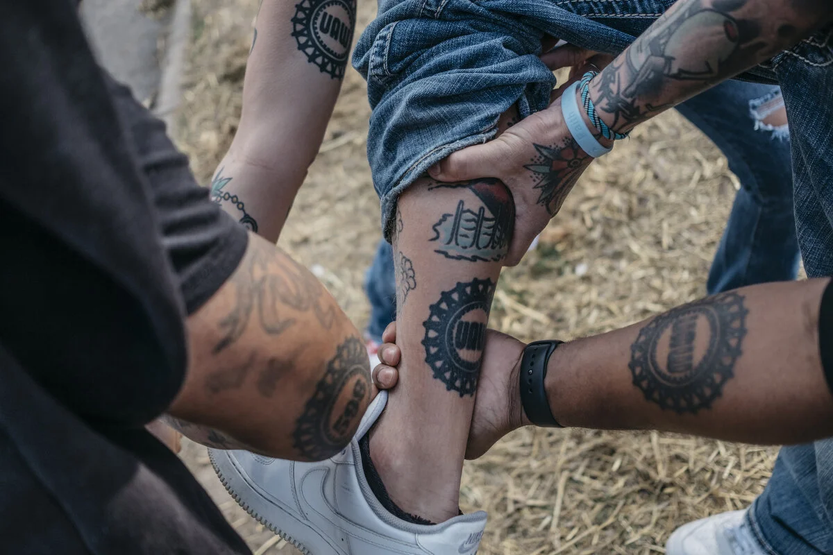  UAW members show off their tattoos for a portrait outside Flint Assembly in Flint, Mich. on Friday, Oct. 25, 2019.  