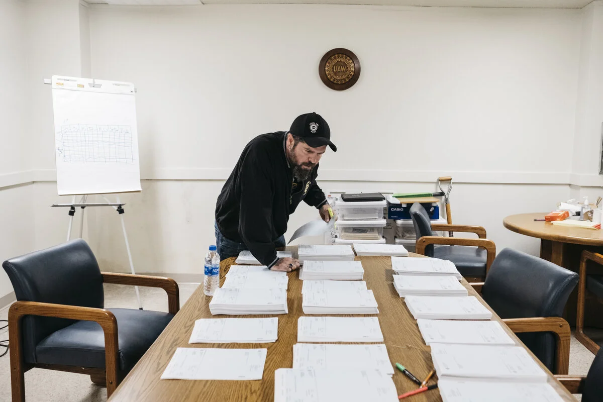  UAW Local 598 financial secretary Chad Fabbro, 44, of Vassar sorts through strike checks in the hall's basement on Friday, Oct. 18, 2019 in Flint, Mich. Each Friday Fabbro and members sort through and confirm each check for the local's more than 5,0