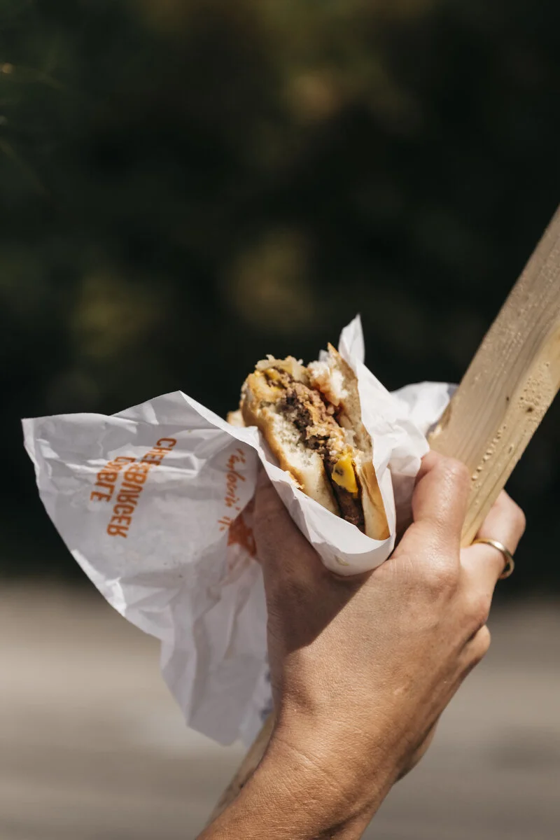  UAW Local 598 member and Aramark Sanitation employee Amanda Van Leuven, 40, of Flushing eats a cheeseburger while holding onto her sign outside the General Motors Flint Assembly Plant during the eighth day of the strike on Monday, Sep. 23, 2019 in F