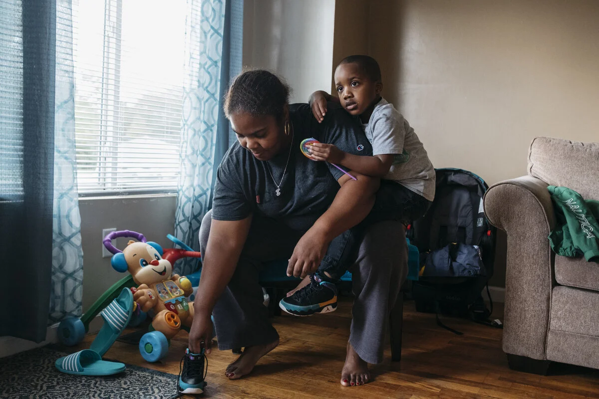  Erica Thompson, 46, helps her grandson Mason Butler, 4, get dressed at her home on Saturday, Oct. 12, 2019 in Flint Township, Mich. Mason is autistic and Erica helps cares for him daily because of his mother's work schedule.  Erica Thompson was hire