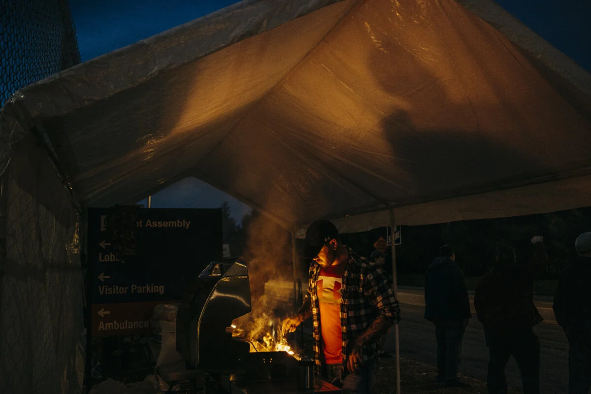  General Motors employee of 14 years Chris Snooks, 34, of Swartz Creek grills outside the General Motors Flint Assembly Plant during the 25th day of the strike on Thursday, Oct. 10, 2019 in Flint, Mich.  