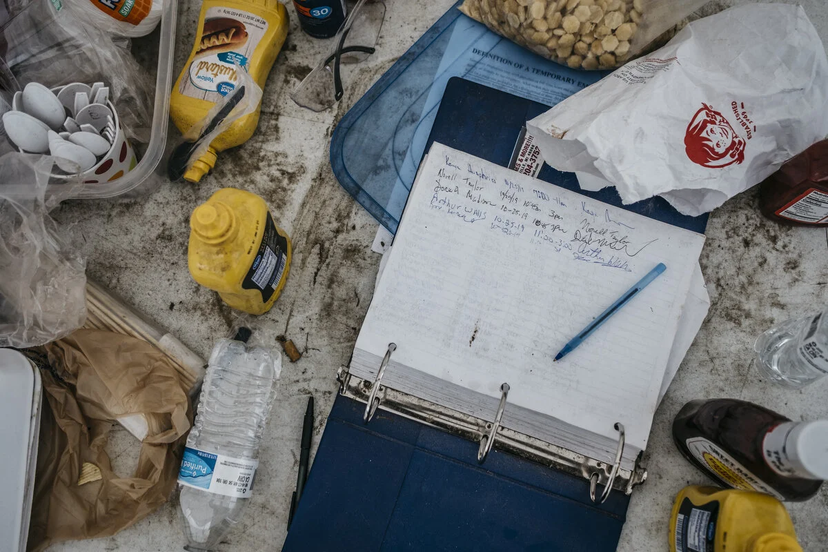  Food scraps and the sign-in sheet sit in a tent in front of the Flint Assembly Plant in Flint, Mich. on Friday, Oct. 25, 2019. 