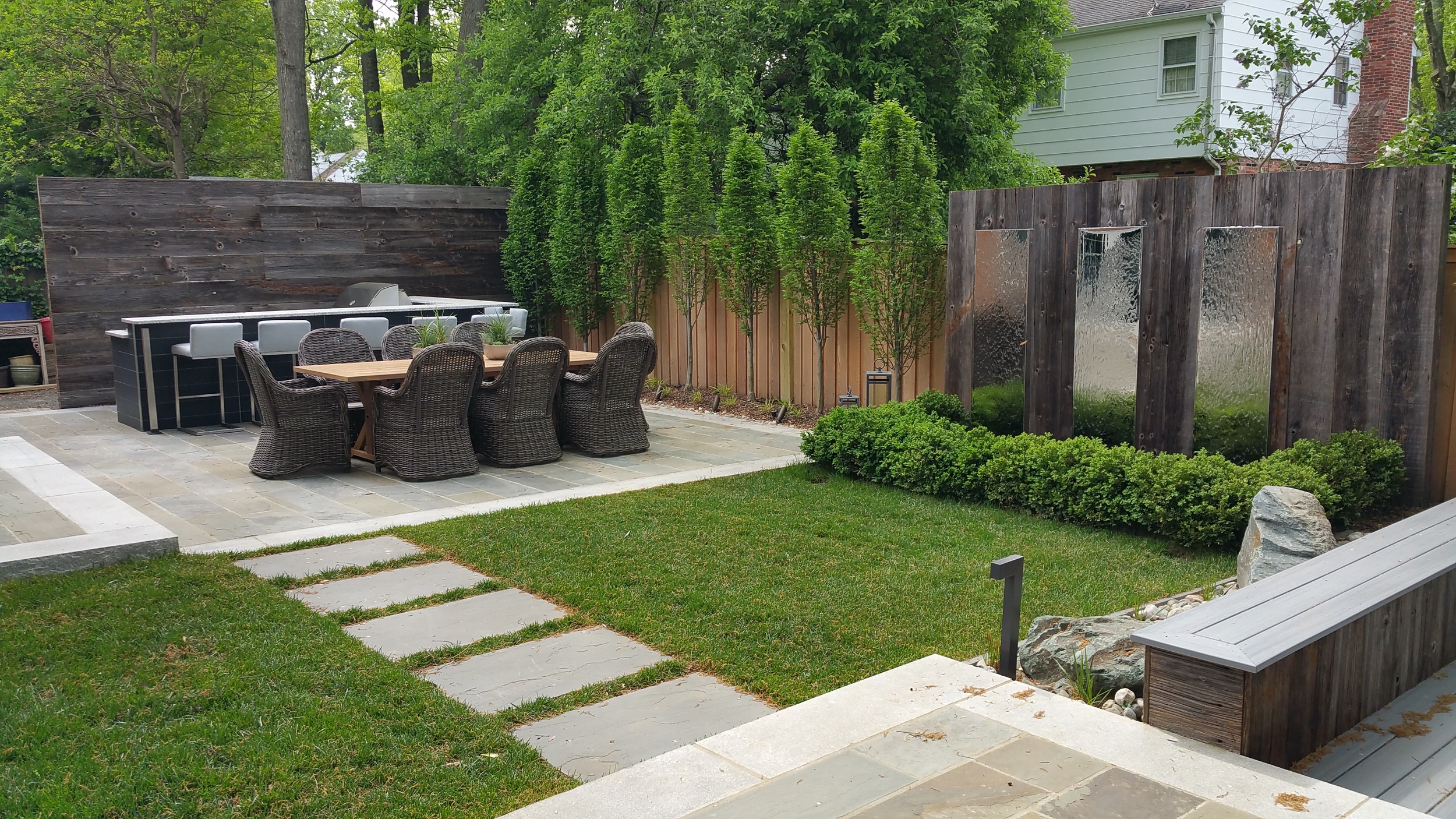 Chrome fountainsline path between outdoor dining and fire-pit patio.
