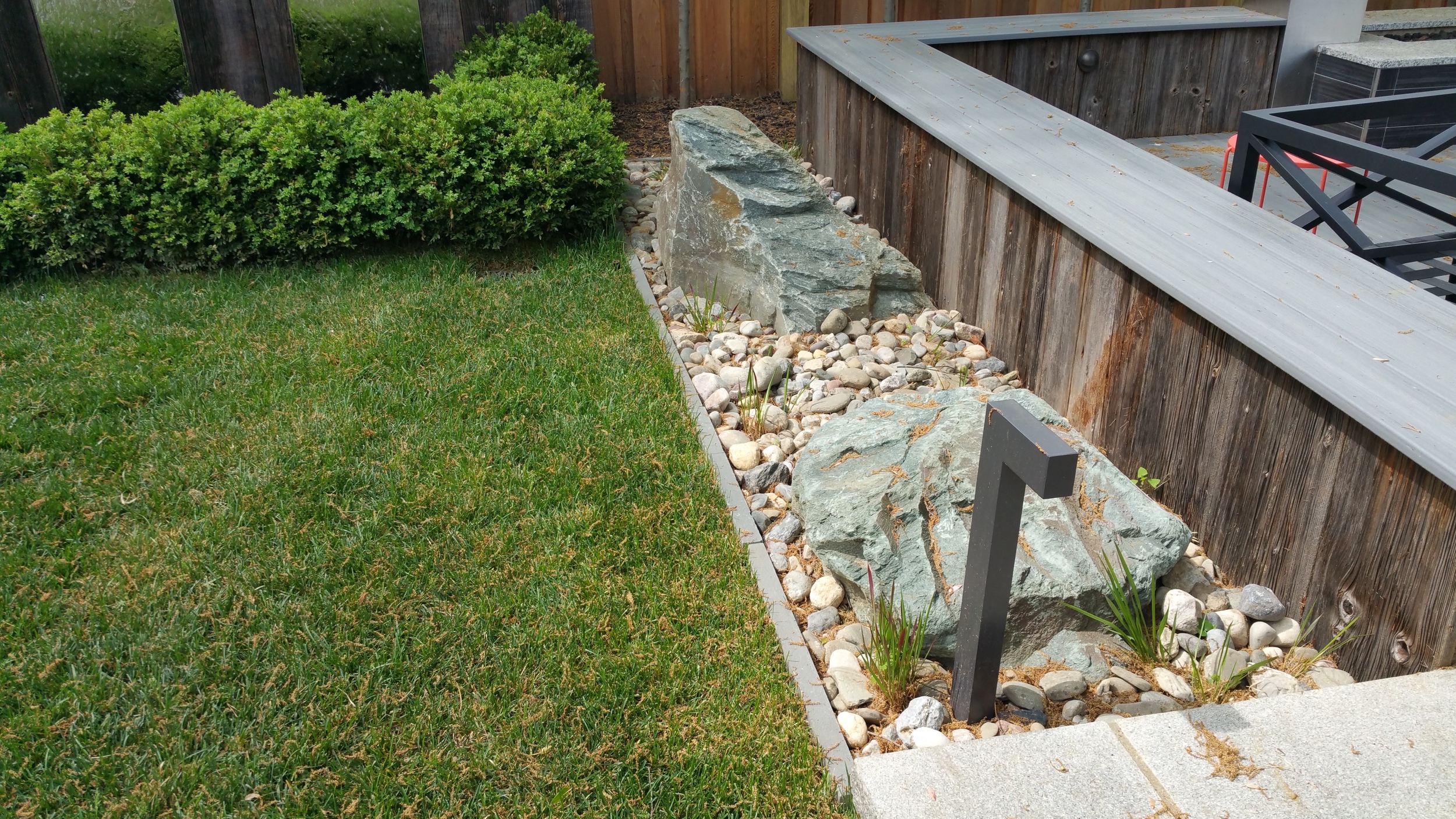 Boulders and rock garden with modern low voltage lighting features.
