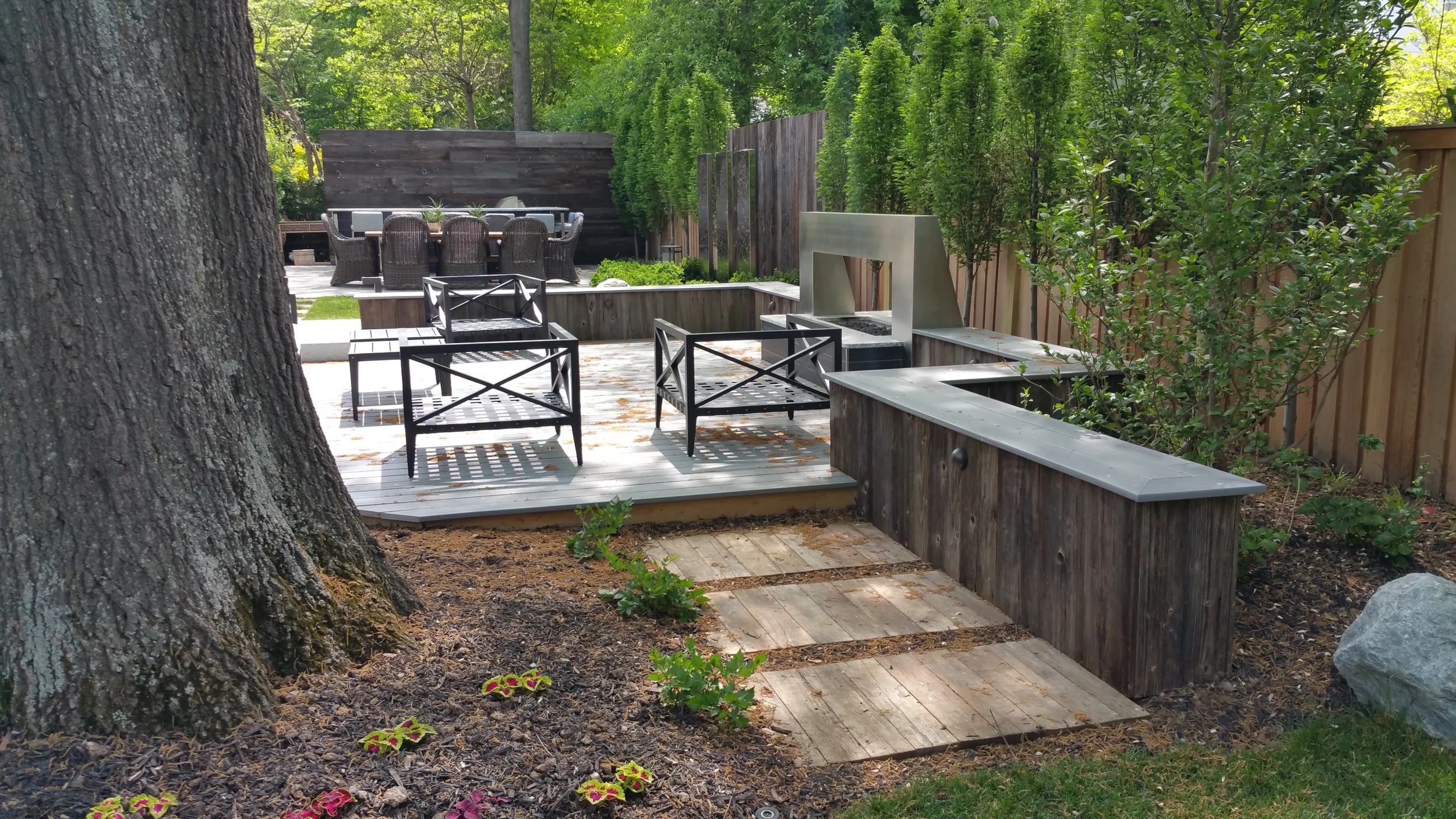 Reclaimed wood seat wall around deck.