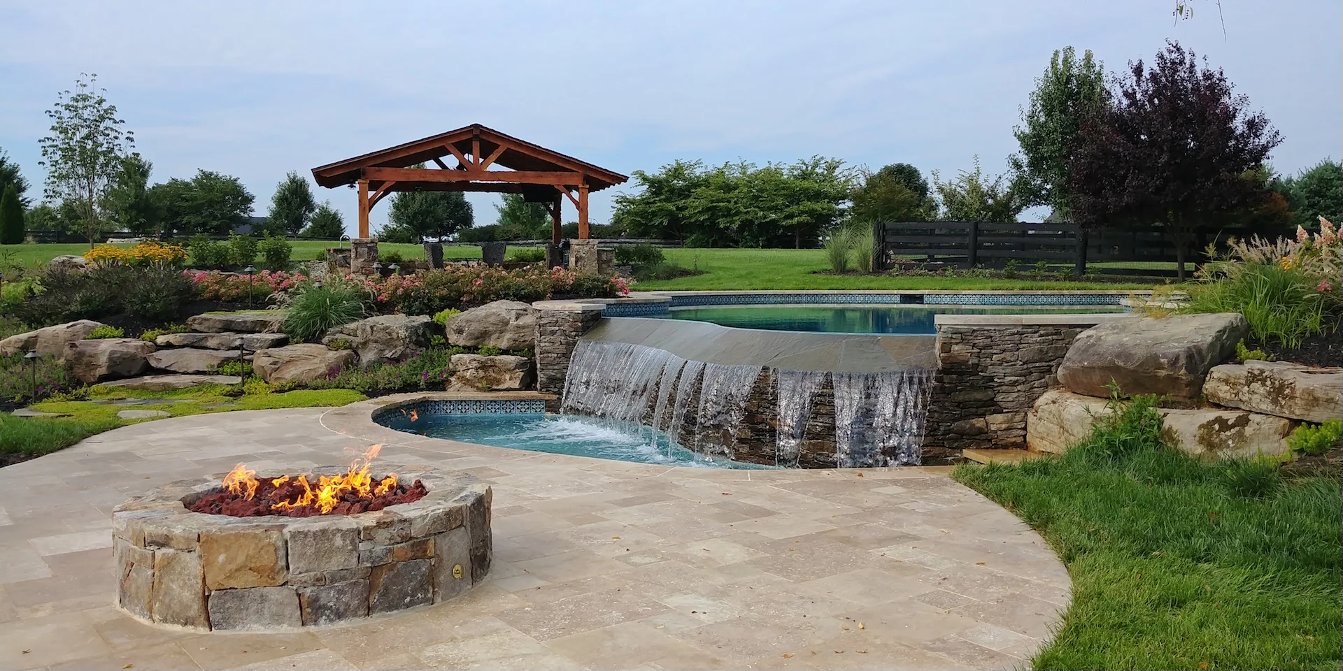 Our wonderful backyard sanctuary in Aldie Virginia that includes and infinity pool (with wading basin), fire pit and outdoor covered kitchen.