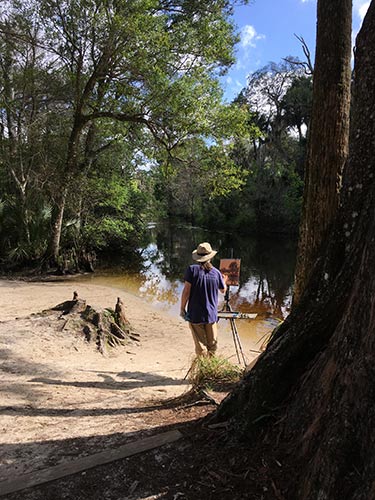 Judge Jim McVicker carved out some time to do some painting at the Riverbend Park canoe launch.