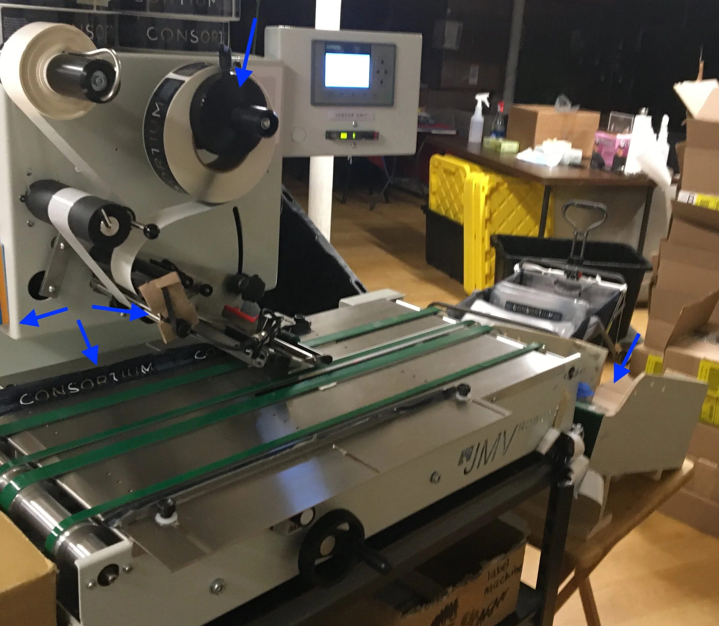 label machine with hacked control knob, conveyor track, tension regulation, and output tray