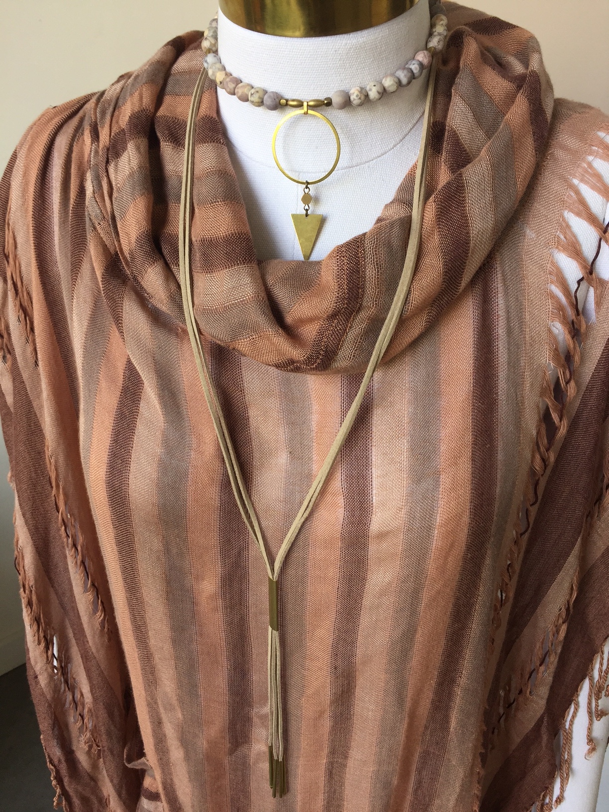 And if you're still looking to keep it a bit boho, try a poncho with one of our bolos and a beaded choker.