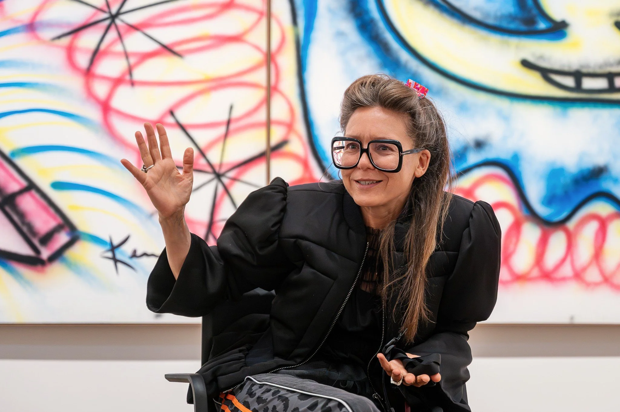 Angela Stief giving a talk in the KAWS exhibition (20260422-190252_albertina_kaws_6295.jpg)