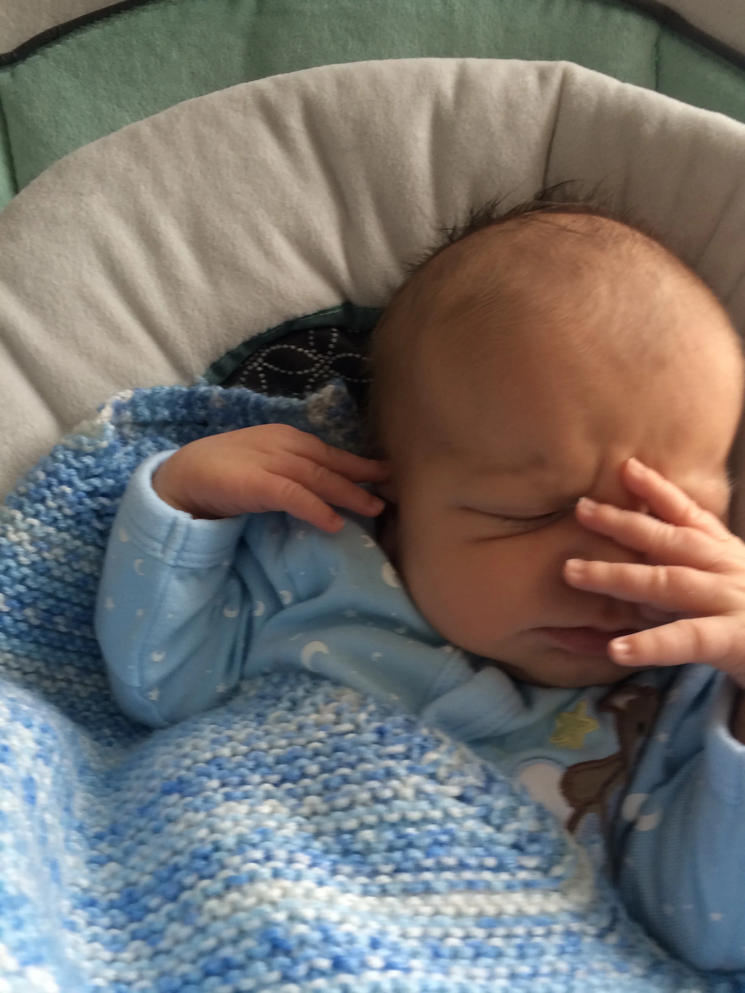 Baby Felix sleeping peacefully in his swing.