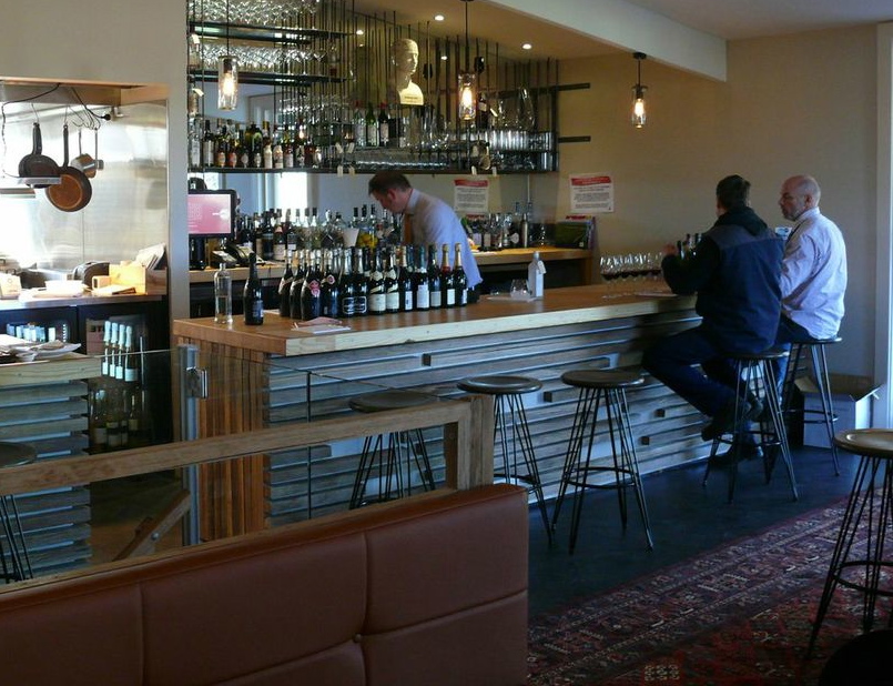 A view of the long bar at the Salopian Inn with its golden top of recycled bowling alley wood. Photo: Peter Coombs