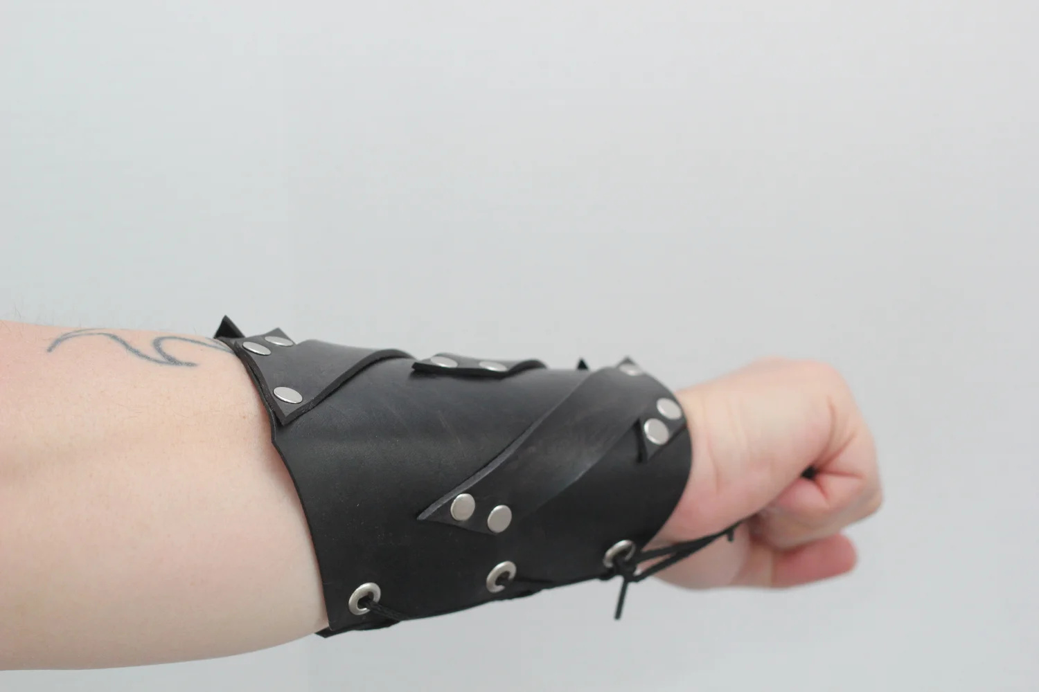Black leather bracer with abstract strap design — Bjorkman