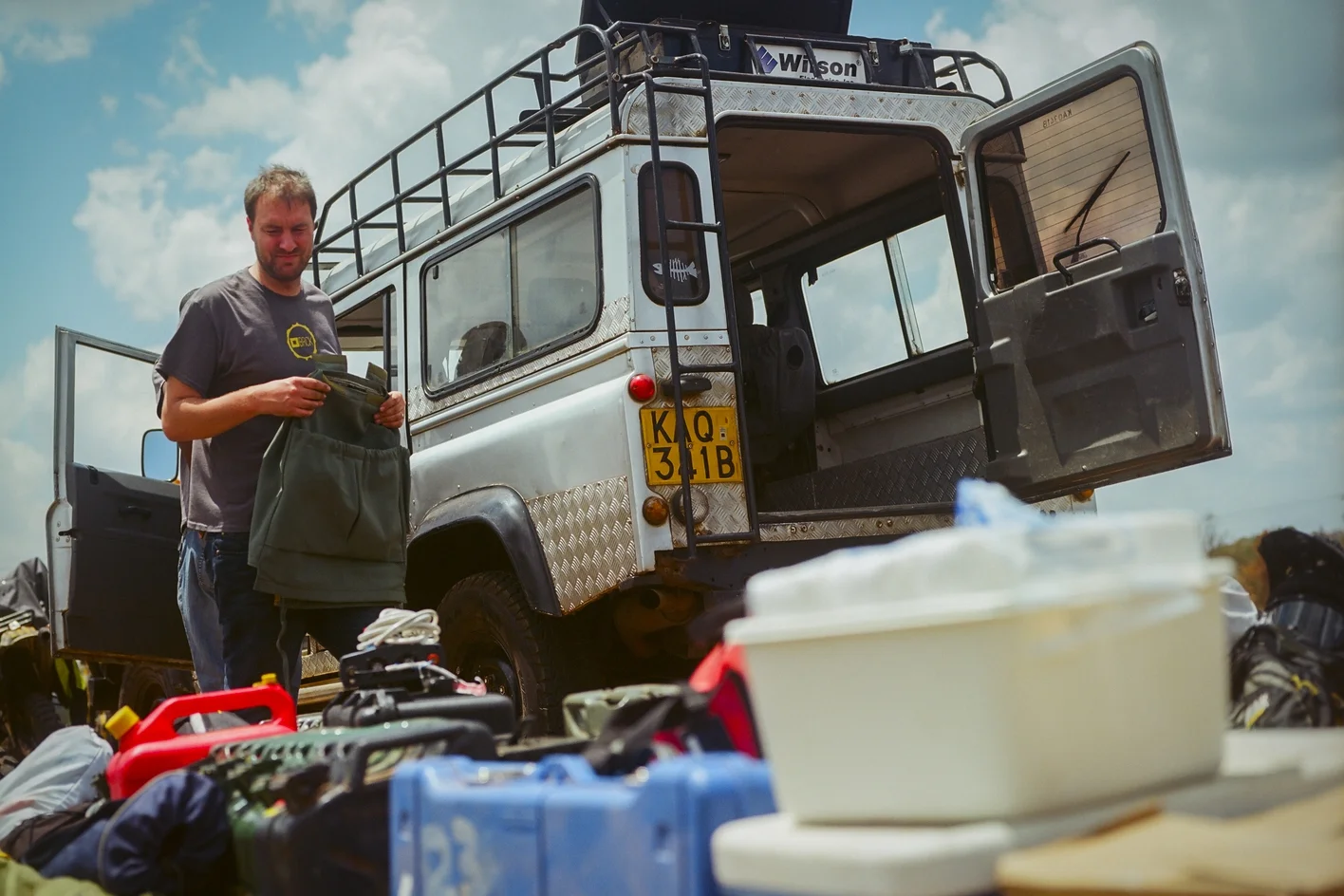 Reg Orton unloads the BRCK team's Land Rover Defender 110 after it broke down early on the first day of the journey. In addition to the food, water, supplies, and cargo for the journey, the team packed fuel for two days' worth of travel.