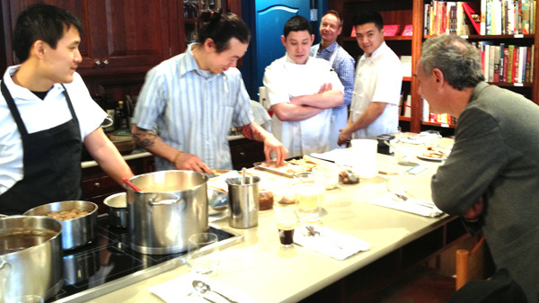 Celebrated chef Ferran Adria of elBulli Foundation watches as Jack Chen and David Gunawan of Farmer's Apprentice and Quang Dang and Alex Hon of West prepare brunch at Books to Cooks in Vancouver on March 9. — Image Credit: Martha Perkins