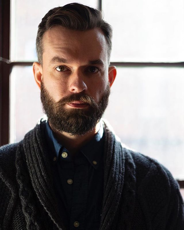 @benstaham poses in a smoking sweater; imaginary tobacco pipe out of frame.