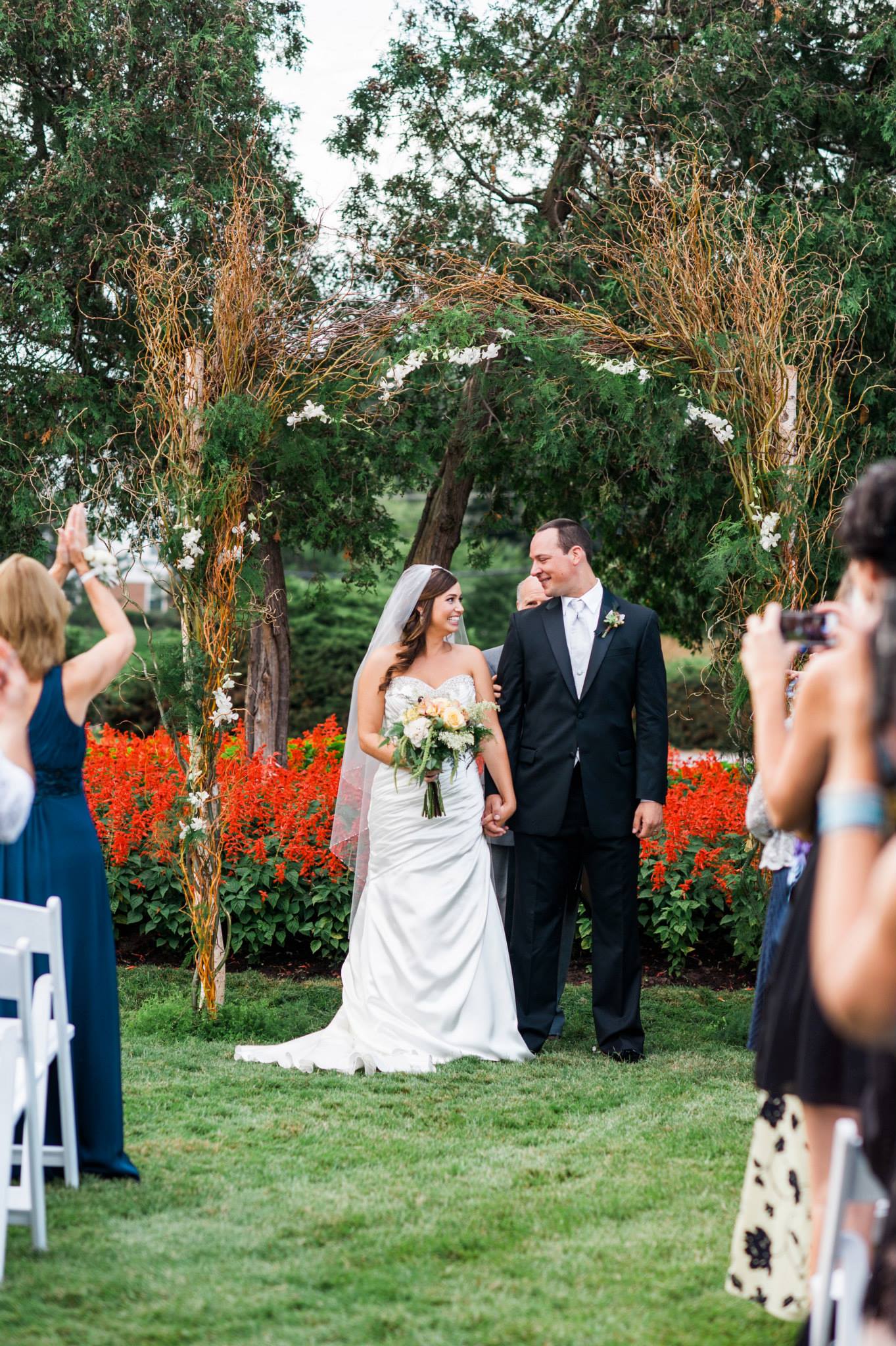 Her composite ceremonial arch of birch and willow, such a lovely, glowing couple. 