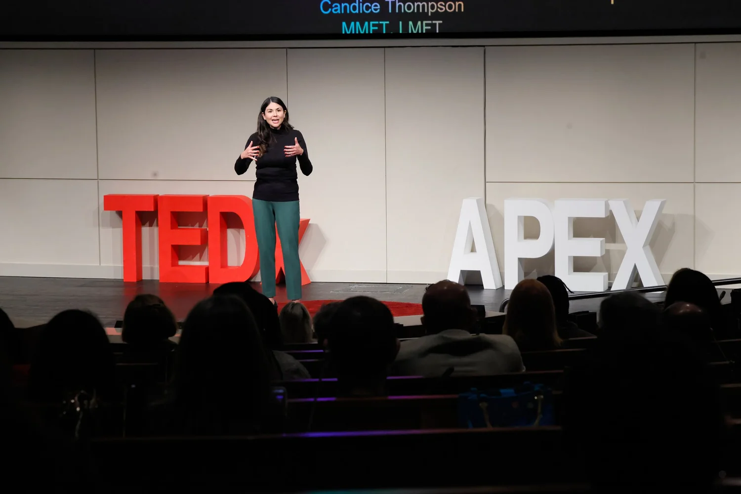 Candice Thompson delivering her TEDx Apex talk on stage
