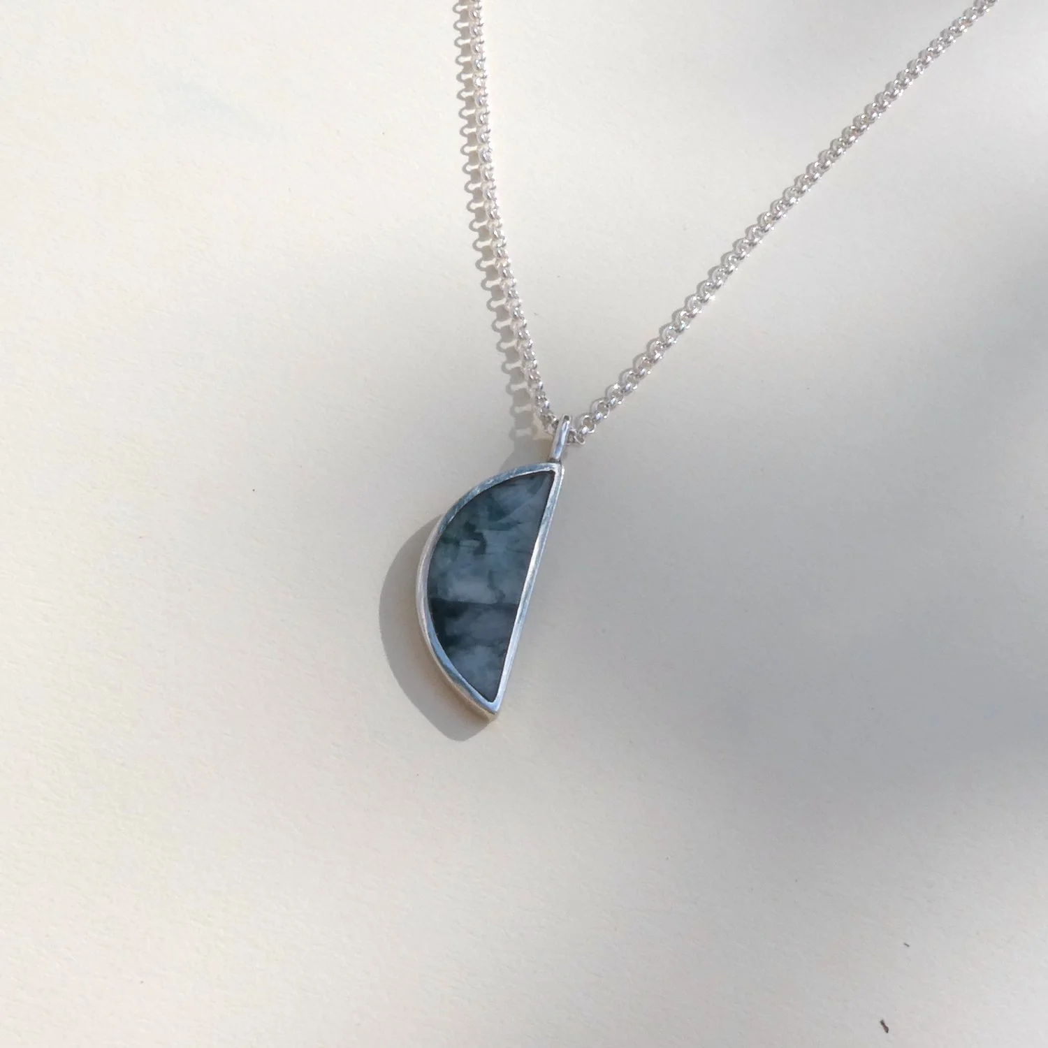 large half circle pendant raw emerald.JPG