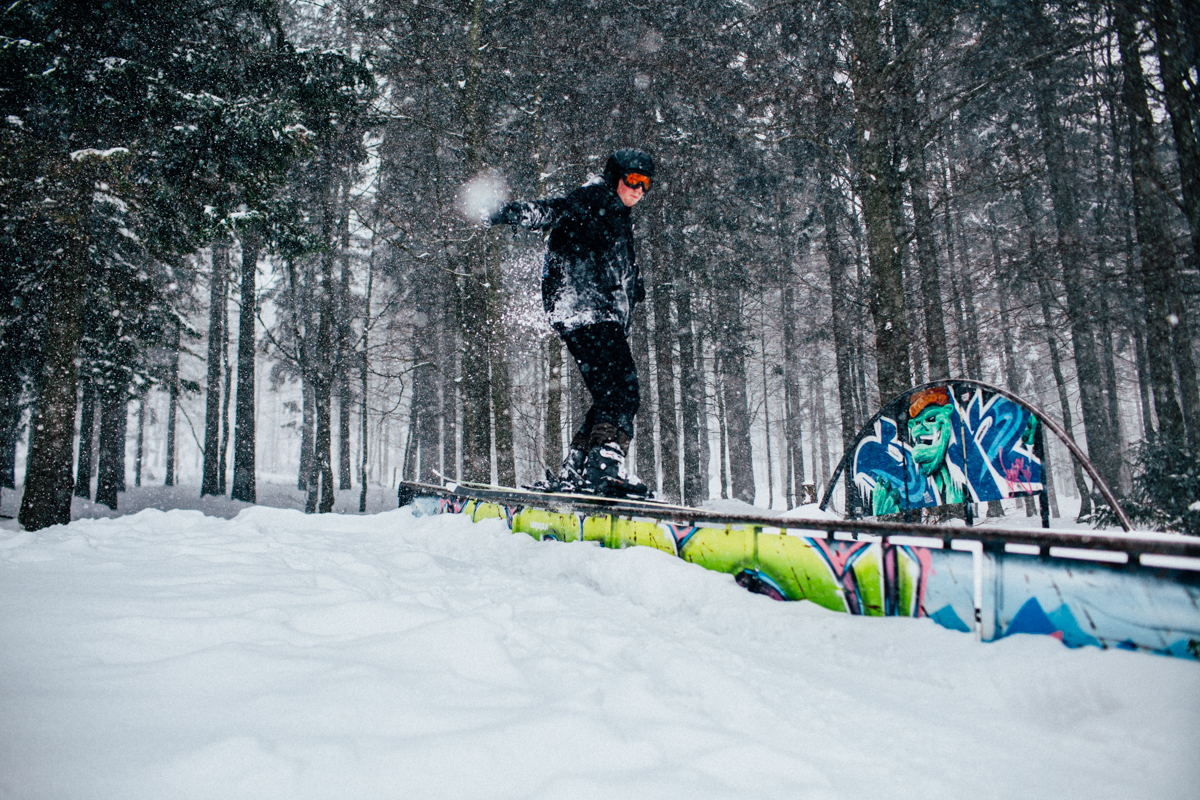 Marcin doing tricks in the snow park. In the background is graffiti by Malik, a homie from my old graffiti crew.