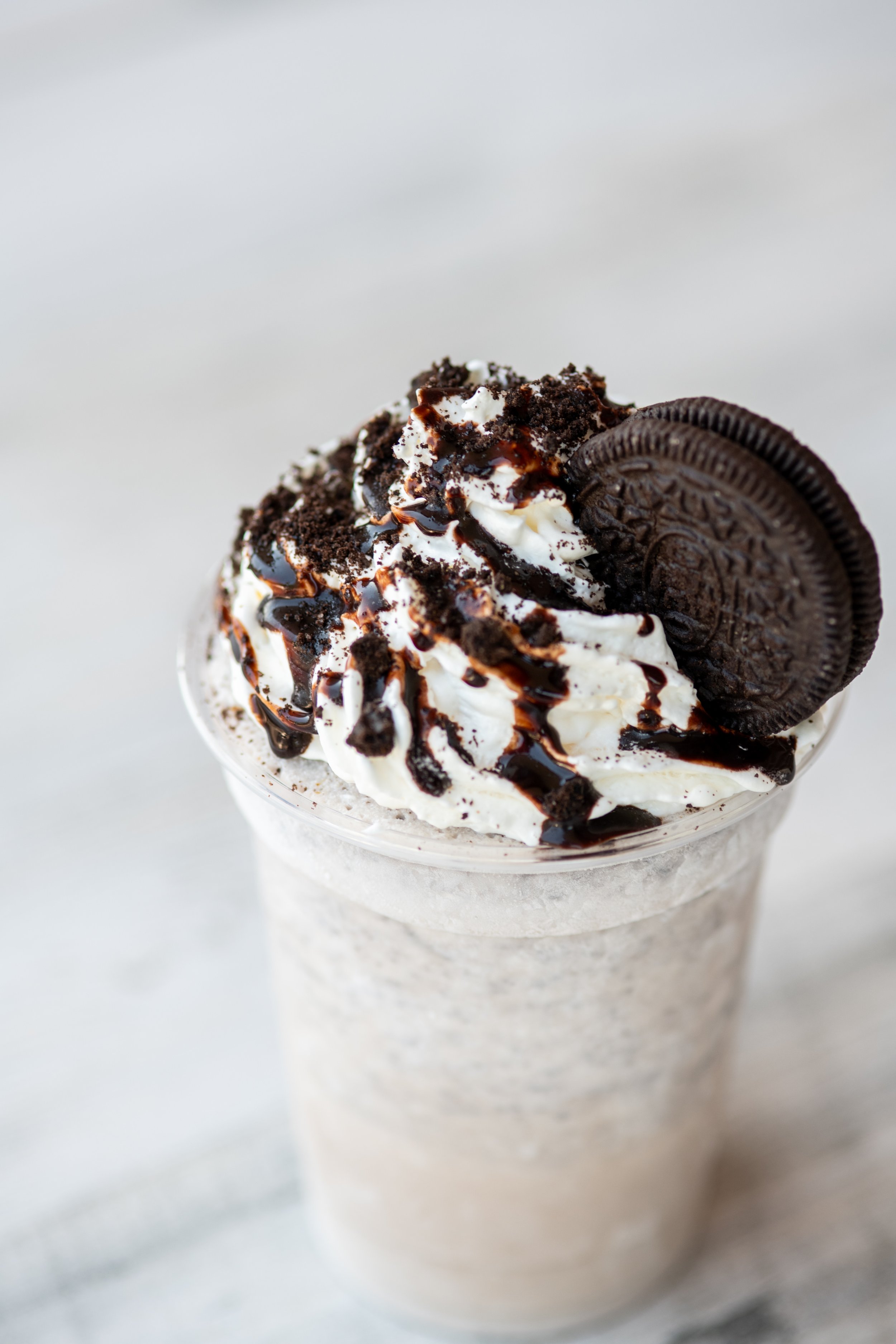 Chocolate Oreo milkshake topped with whipped cream, chocolate syrup, crushed Oreo cookies, and an Oreo cookie garnish.