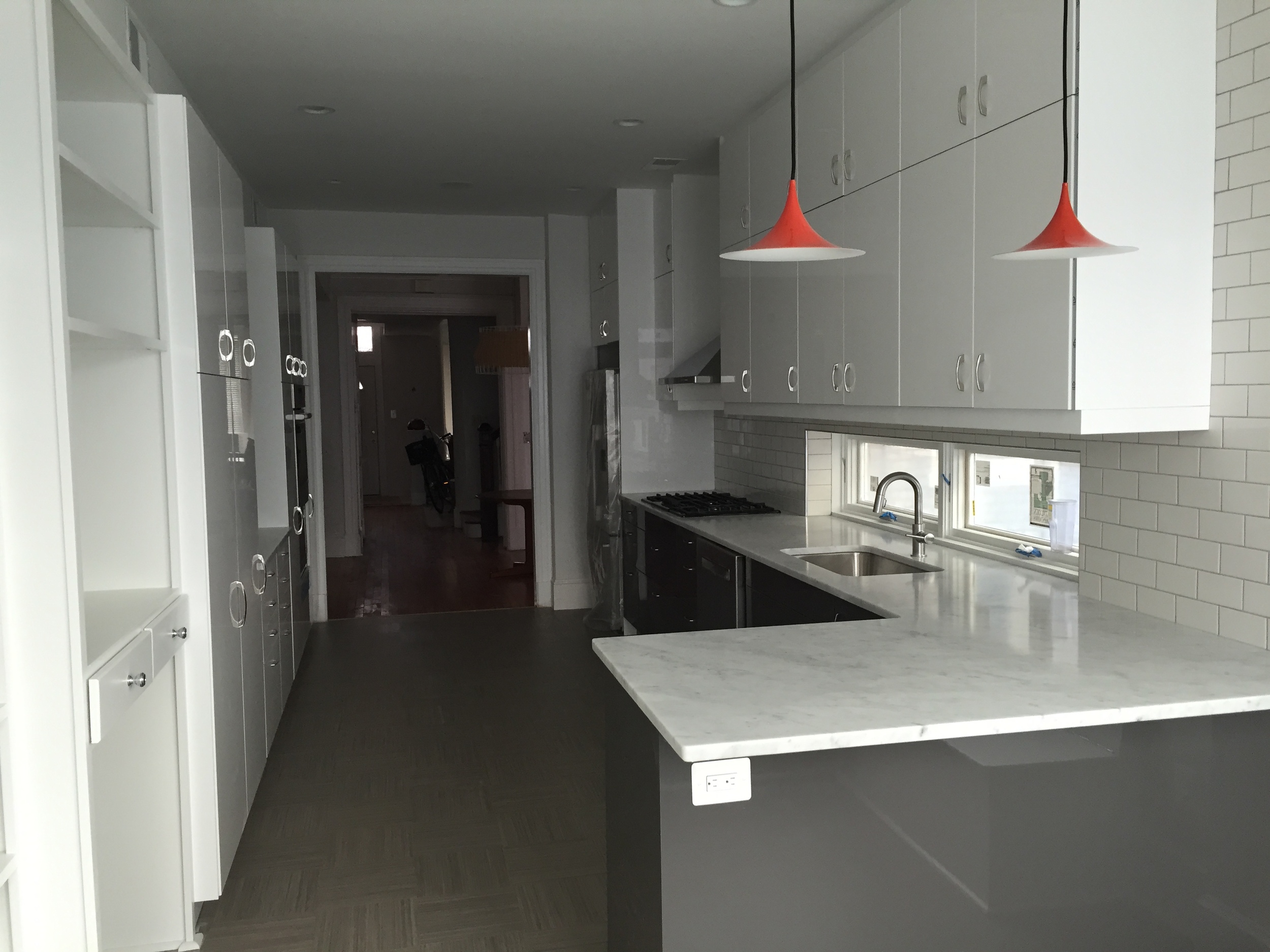 Carrera marble countertops all around, and we chose the two pendant lights from Design Within Reach. We did our cabinets (white uppers and grey below) from Ikea, which was pretty easy but not the cheapest due to the slick modern finish we chose (and how many cabinets we have--packrats!)