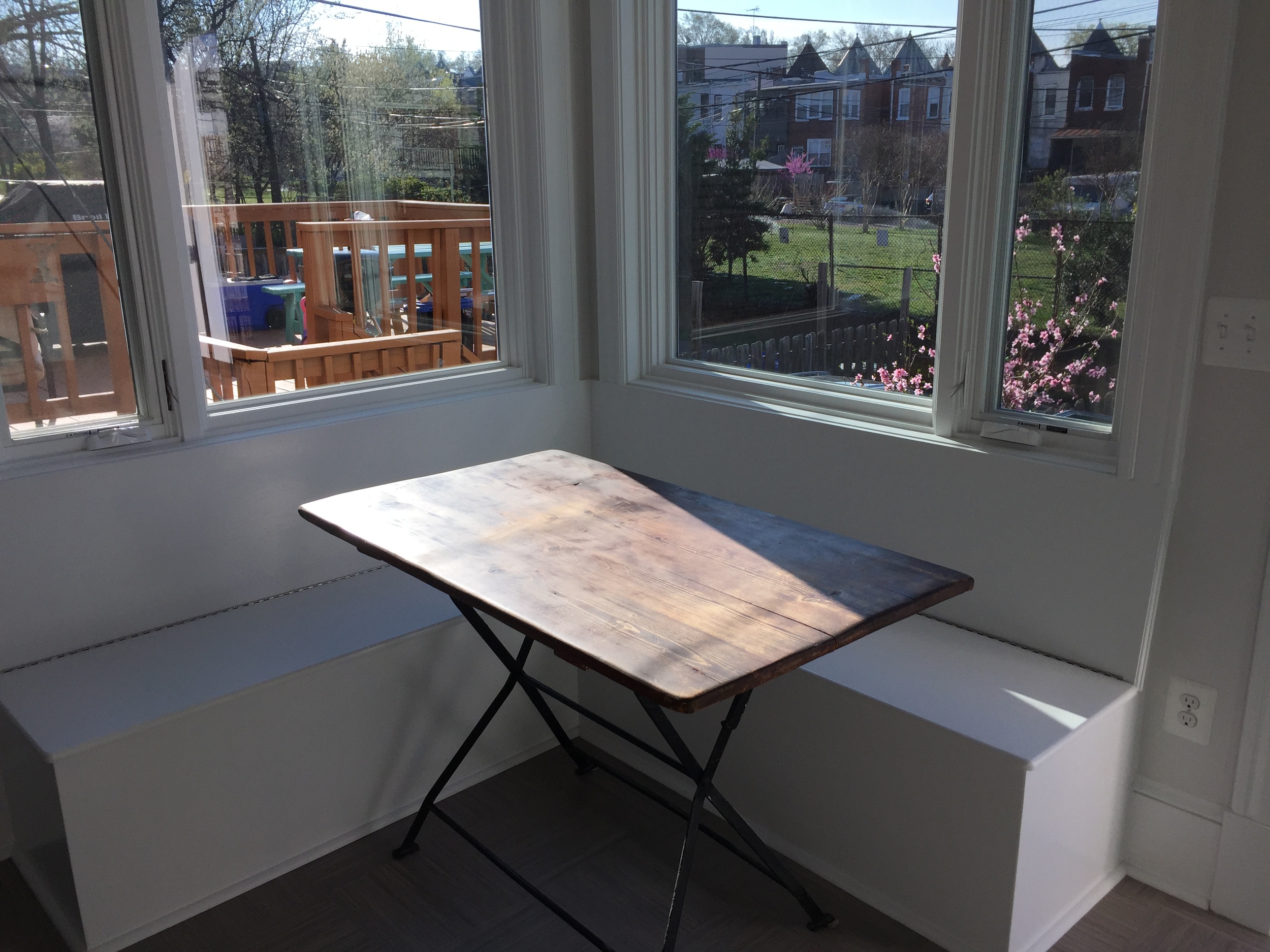 Here's our little breakfast nook--the seats open up to what I think will be toy storage one of these days. Still debating whether to get cushions made to go on these seats....thoughts welcome?