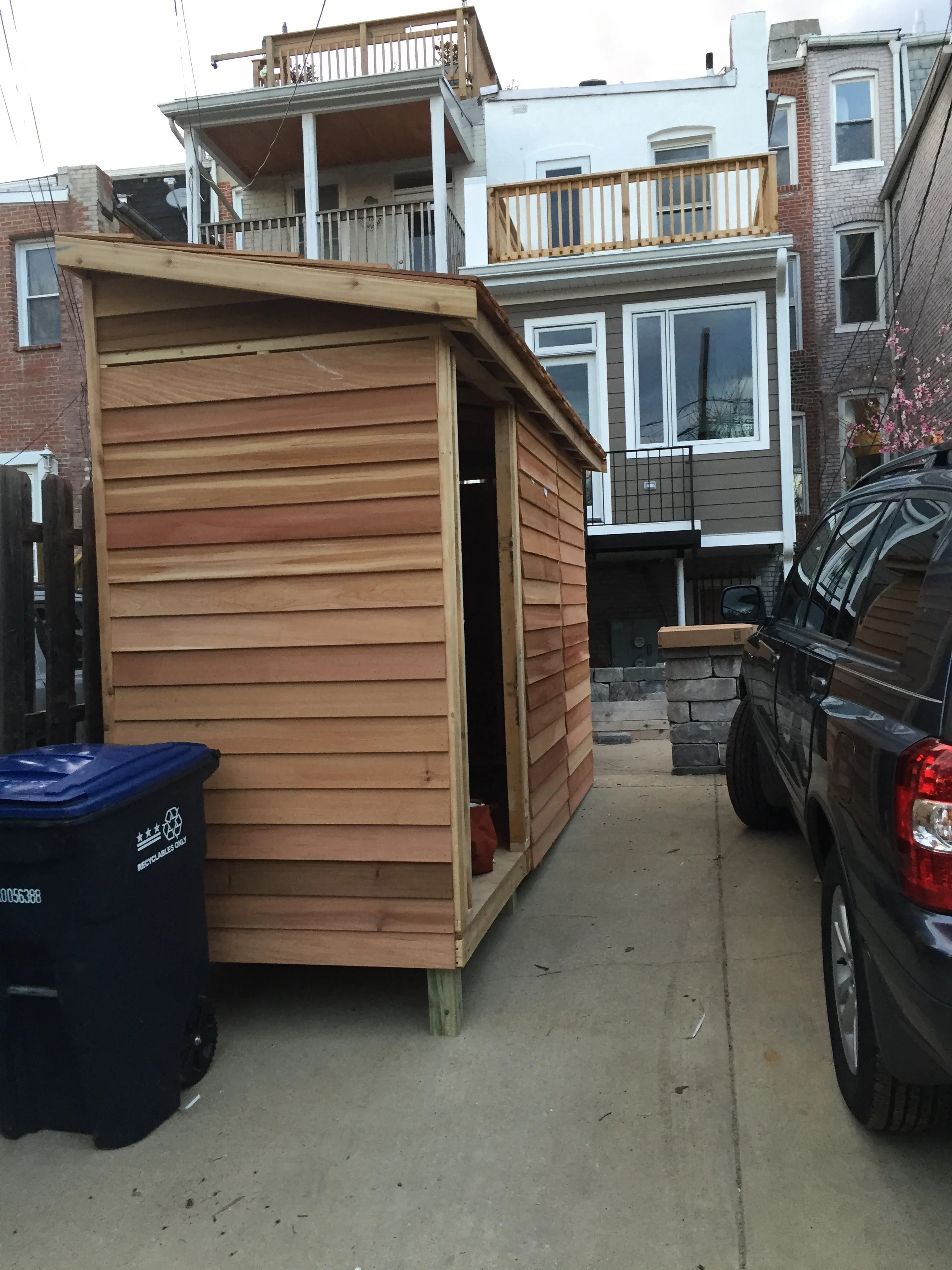 The new Canadian cedar bike shed was constructed from a kit--notice our new deck on the second floor above the kitchen.