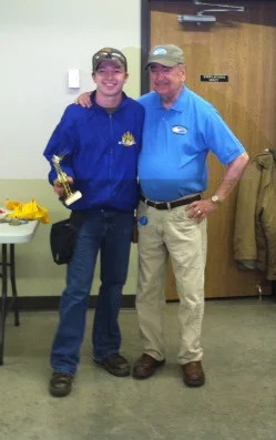 Jacob Goeden is shown accepting his third-place trophy with Minnesota Clay Target Founder Jim Sable.