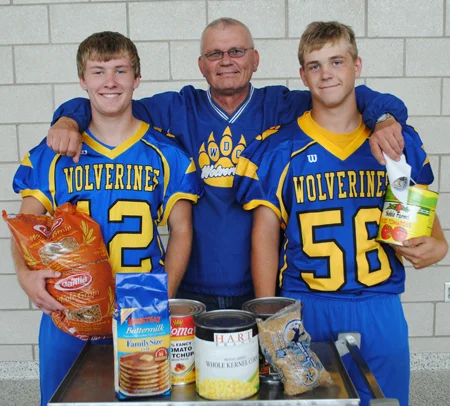 WDC
football players are taking off their pads and helmets for a good cause. Head
coach Howie Kangas, middle, is flanked by senior players, Nick Carlson and
Wyatt Weber. 