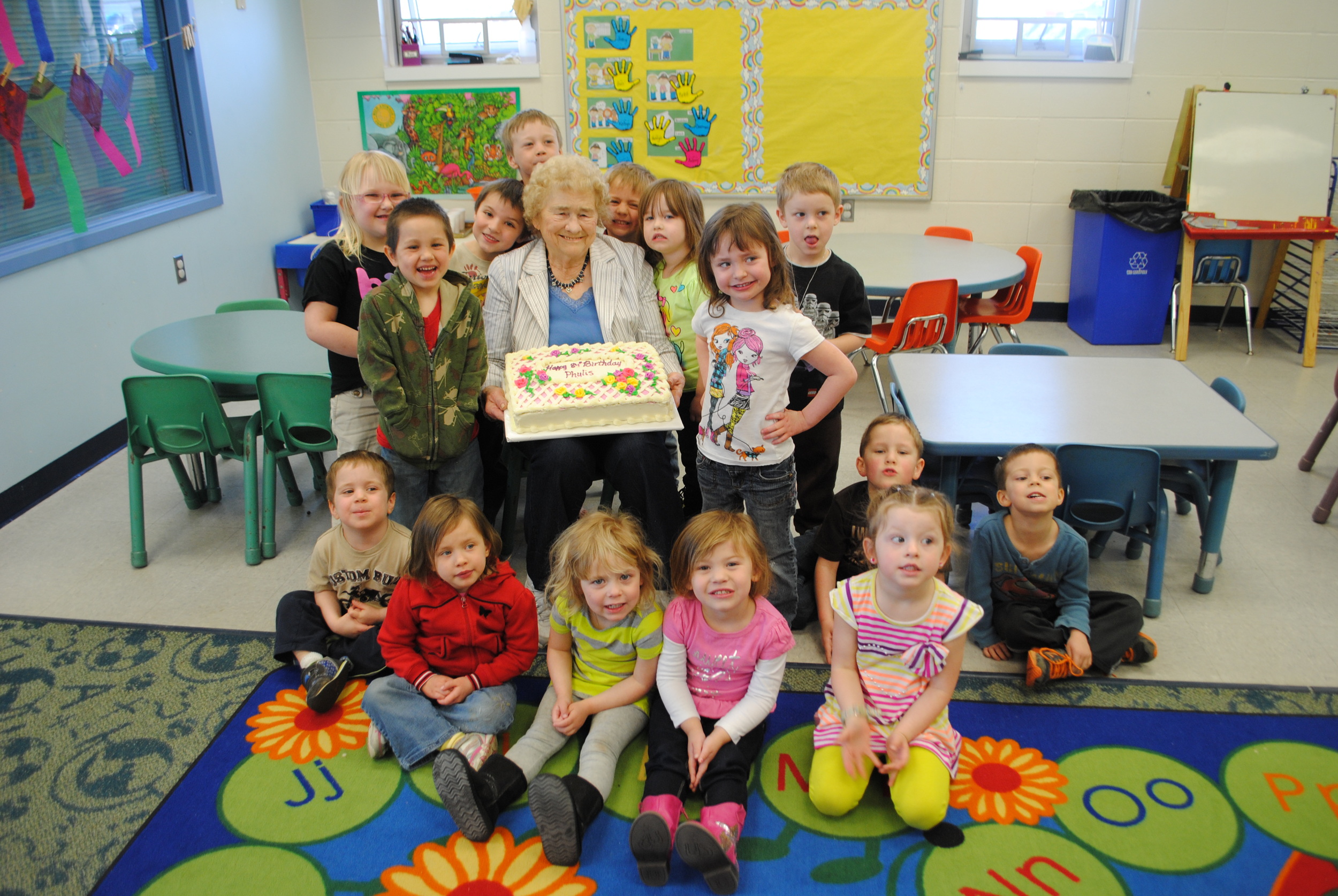 Foster Grandparent Phyllis Jackson celebrated her 84th birthday with WDC Little Kids Club at M|State on Thursday. The kids presented Grandma Phyllis with a homemade card and lots of birthday hugs. (Photo by Dana Pavek, WDC Schools)