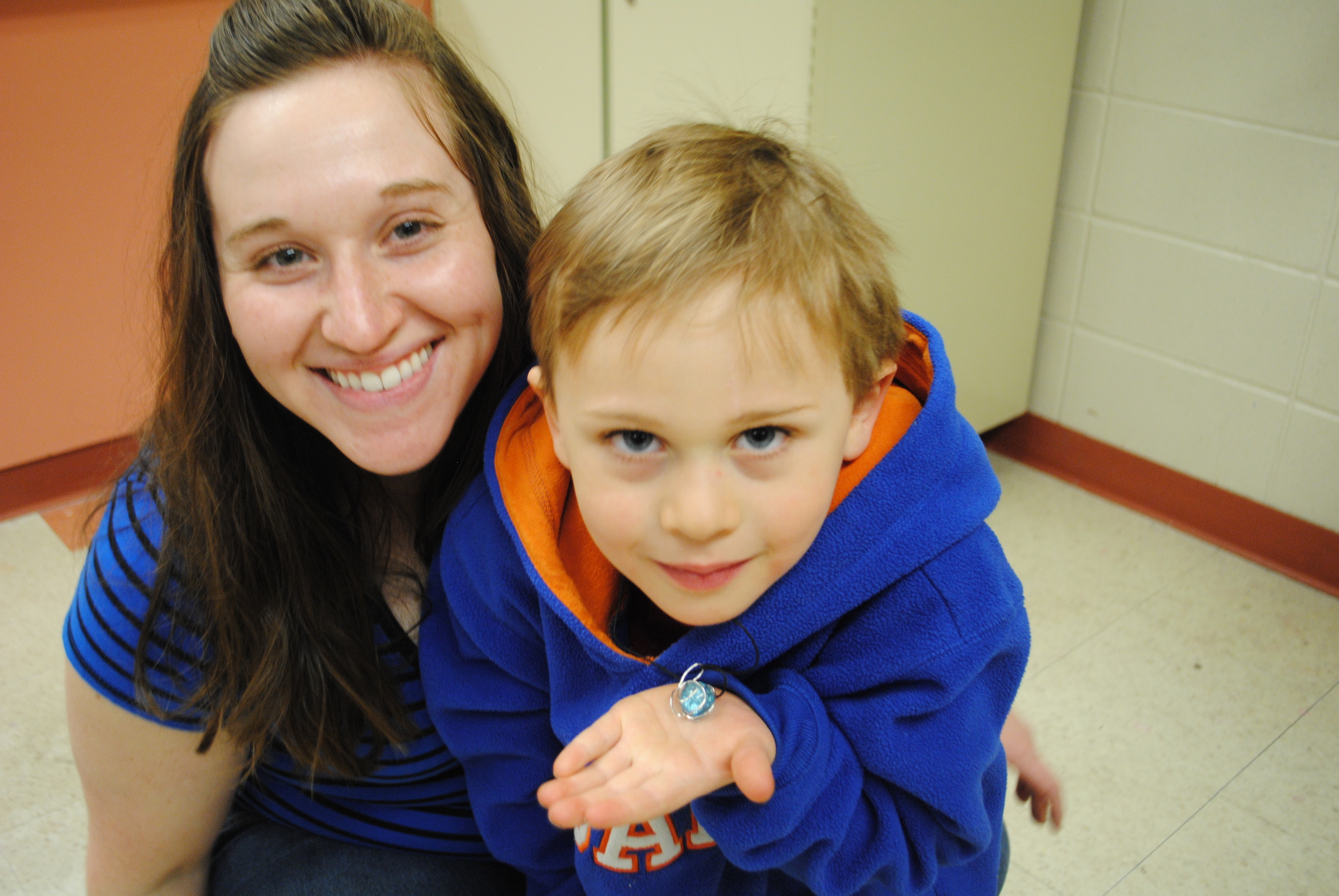 4-H Program Coordinator Virginia Hendrickx (left) showed students how to make a marble necklace in this week's "Green Adventures" class, which is held Tuesdays after school at WDC Elementary. Andrew Brezcinski shows off his beautiful marble necklace that he plans to give to his mom on Mother's Day. (Photos by Dana Pavek, WDC Schools) 