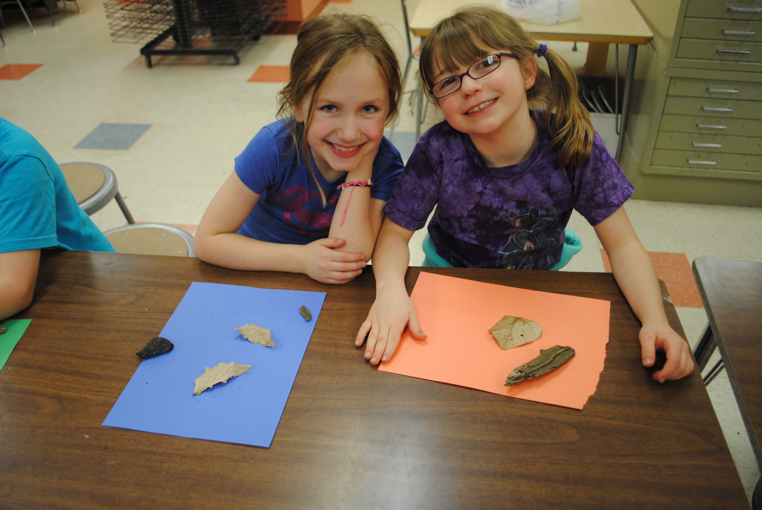 Libby Hartman, left, and Macey Goeden arrange their objects on their paper for their sun fades.