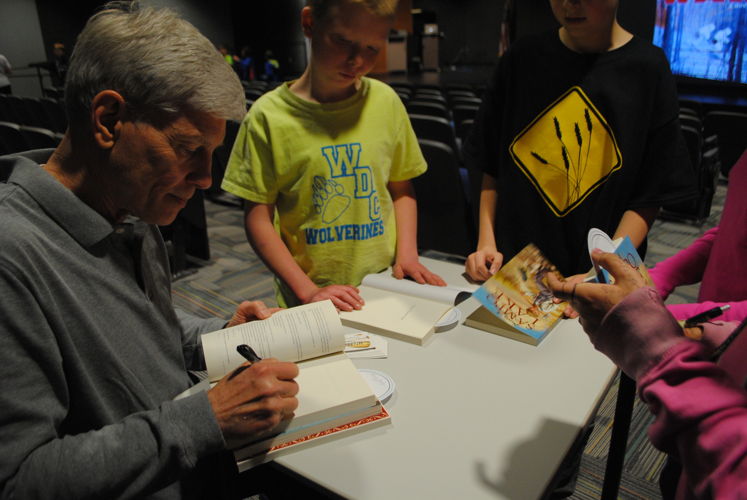 Durbin signing books for WDC students, who were excited to visit with the author one-on-one.