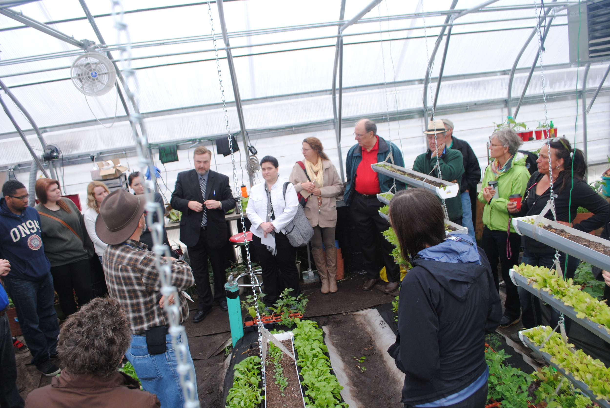 WDC Superintendent Lee Westrum (fifth from left) talks about the funding sources involved in making the greenhouse a viable and successful venture for the school. (Photo by Dana Pavek, WDC Schools)