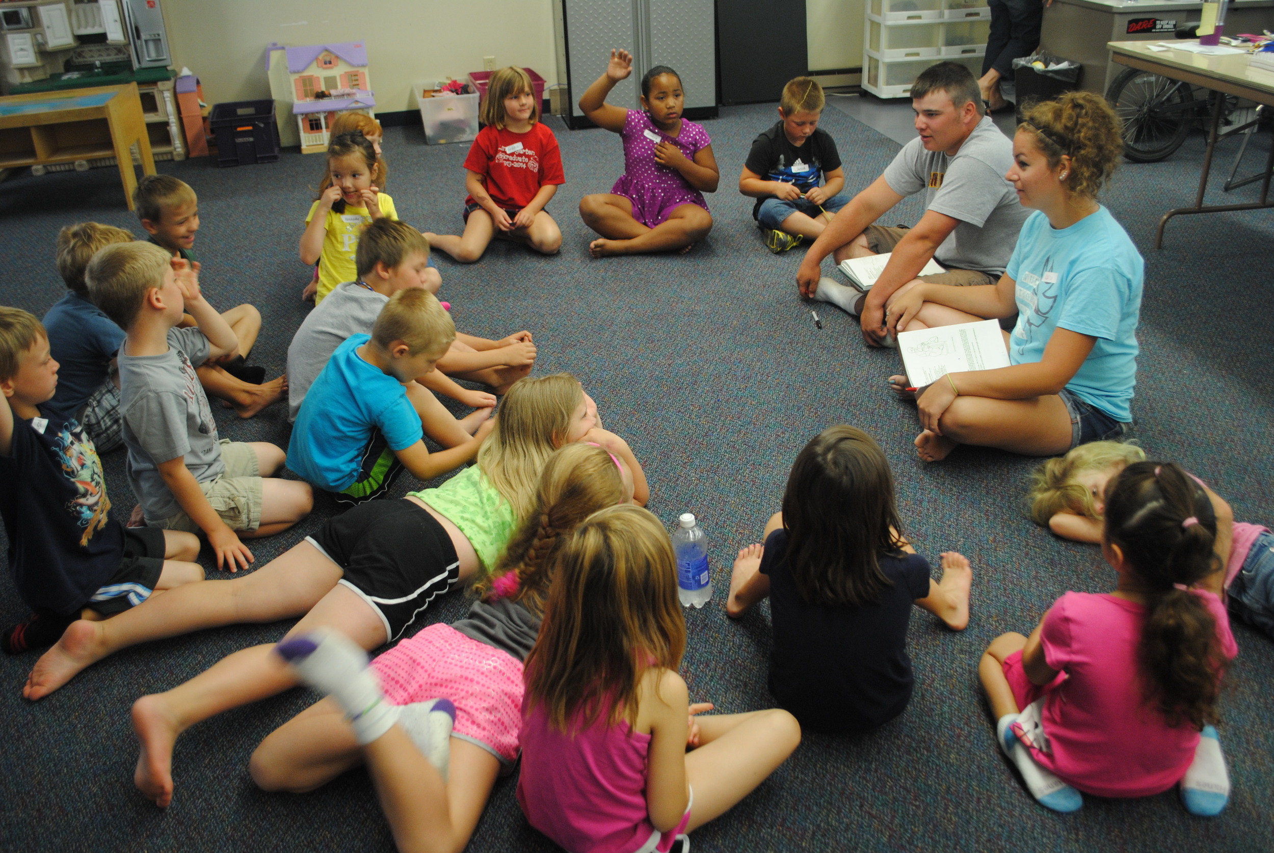 Joey Price and Abby Wegscheid, at right, visit with the younger WDC Kids Club youth on July 22 about appropriate touches. 