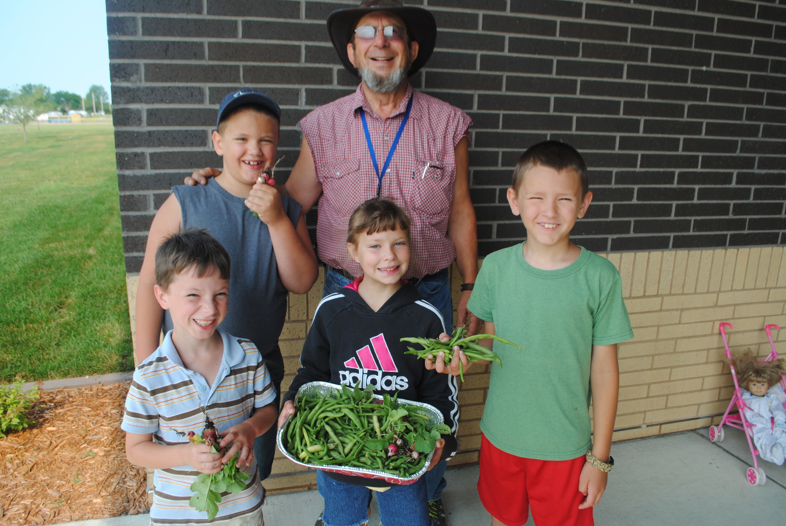 These kids picked and delivered fresh green beans and radishes to the elementary school recently as part of a gardening class. Front, from left: Diego Shaw, Mia Shaw and Colby Schmid; back row, from left: Carter Worden and Ed Lewis, instructor. "Harvest Time at the School Garden" is sponsored by WDC-B Community Education. (Photos by Dana Pavek, WDC Schools)