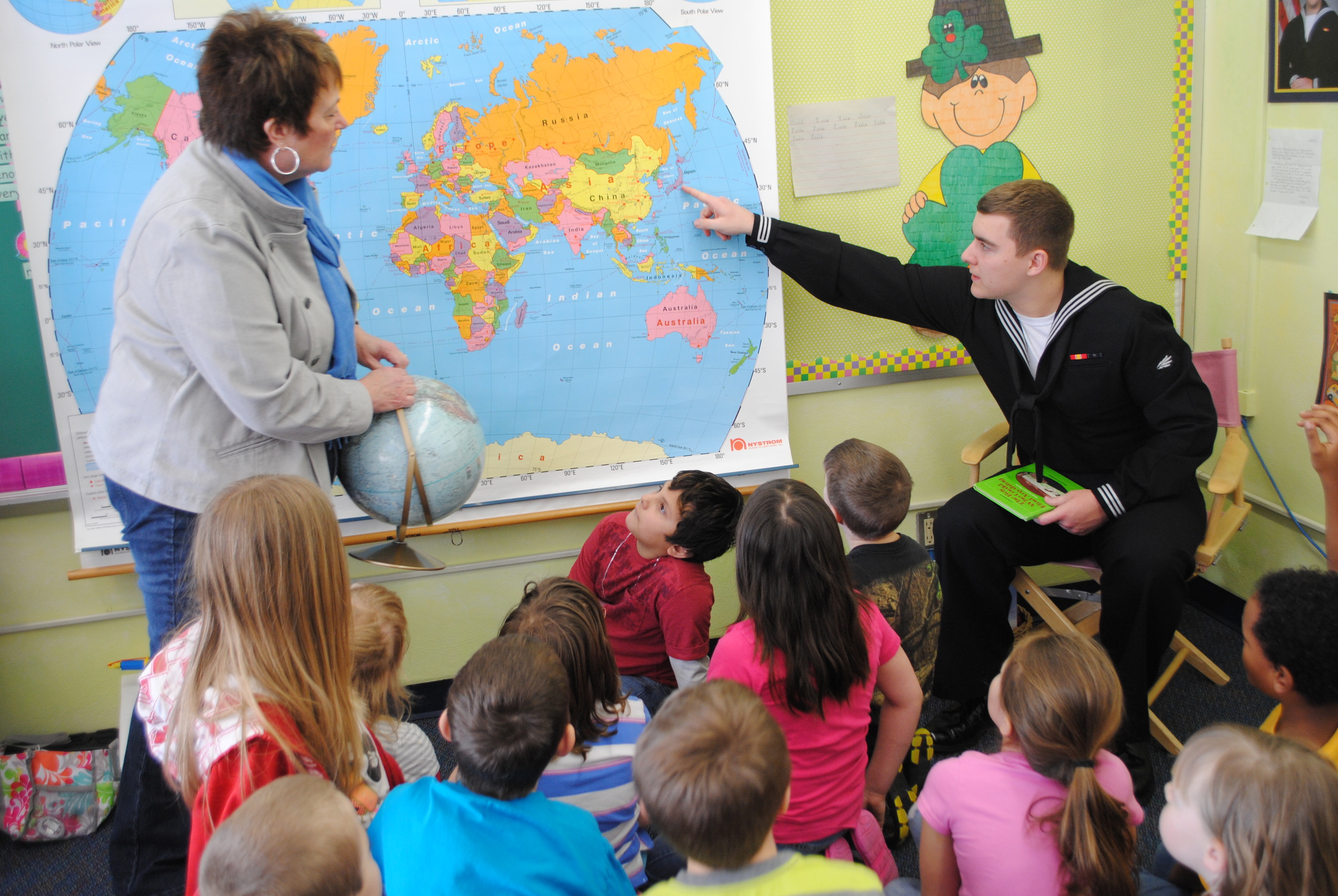 Last year, Eliah Anderson surprised Junelle Jackson's second-grade students by visiting the class and being a guest reader. The class had been corresponding with him while he was receiving his training in the states. In this picture, Anderson points to the naval base in Japan, where he is now stationed. The 2012 Wadena-Deer Creek graduate is serving in the U.S. Navy. (Photo by Dana Pavek, WDC Schools)