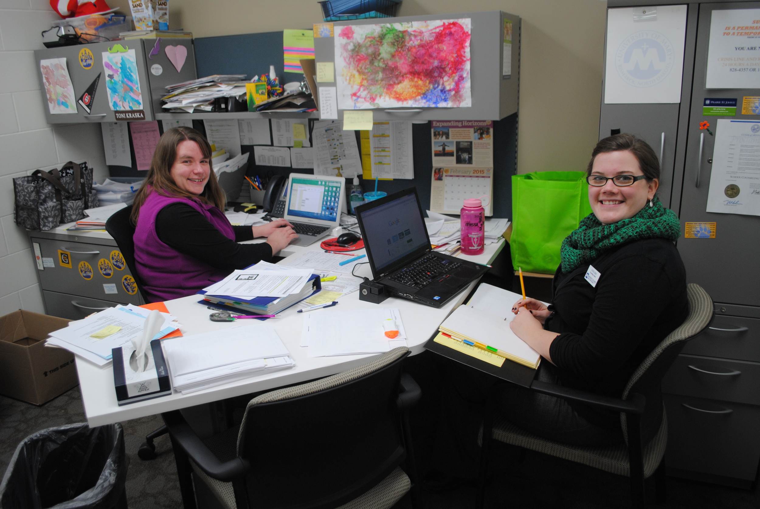 Wadena-Deer Creek Middle/High School licensed counselor Toni Kraska, left, and intern Katie Edin, right, see a steady stream of students throughout the school day at WDC.