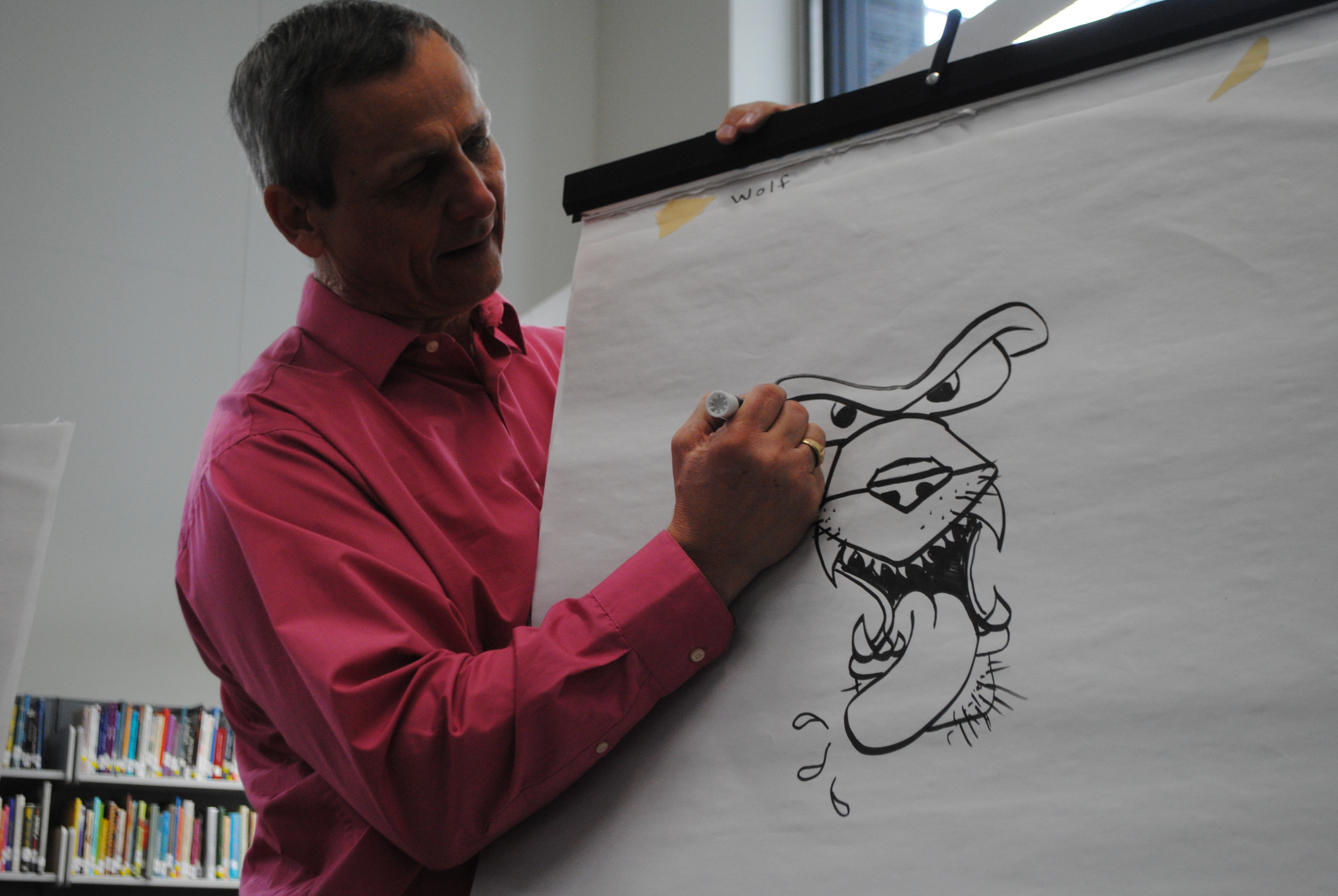 Illustrator/author Gary Harbo shows sixth-grade students how to draw a brow on a wolf during his artist-in-residence visit Thursday, Feb. 5 in the WDC Middle/High School Media Center. Students enjoyed learning cartoon-like drawing techniques from Harbo. (Photos by Dana Pavek, WDC Schools)
