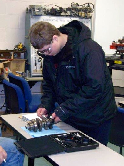 WDC FFA member, Ethan Benson, measures engine parts during the Minnesota FFA Region II Agricultural Mechanics Career Development Event. (Photo by Richard Muckala, WDC Schools)