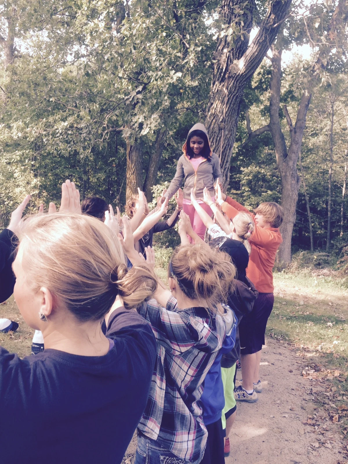 WDC seventh-grader Mona’e Payton is supported by classmates while she stands on a swinging log. The outdoor activity was one of several that focused on teamwork and were part of a day-long retreat at Inspiration Point. (Photo by Toni Kraska, WDC Schools) 