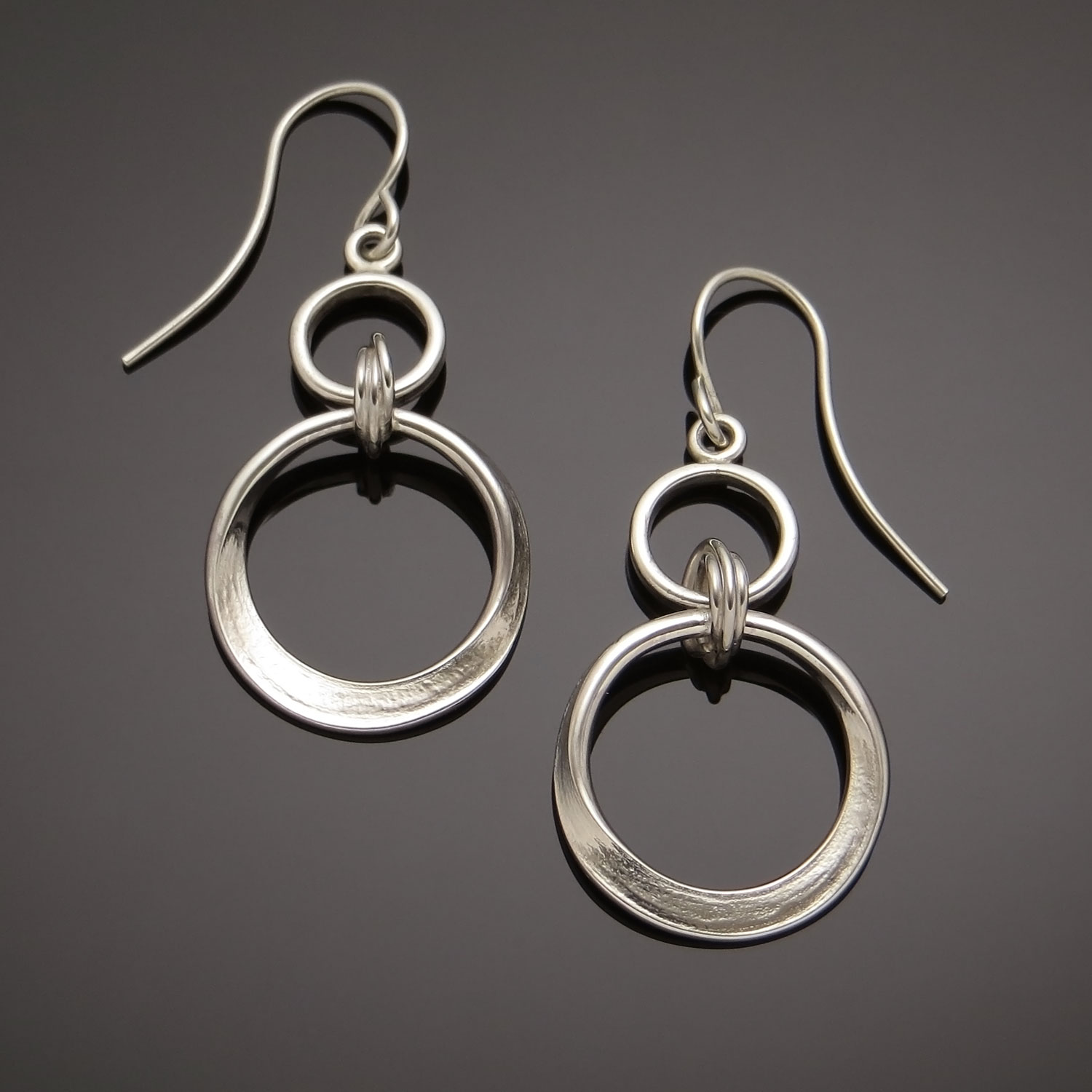 Sterling Dangle Earrings w Mobius loop suspended from a circle