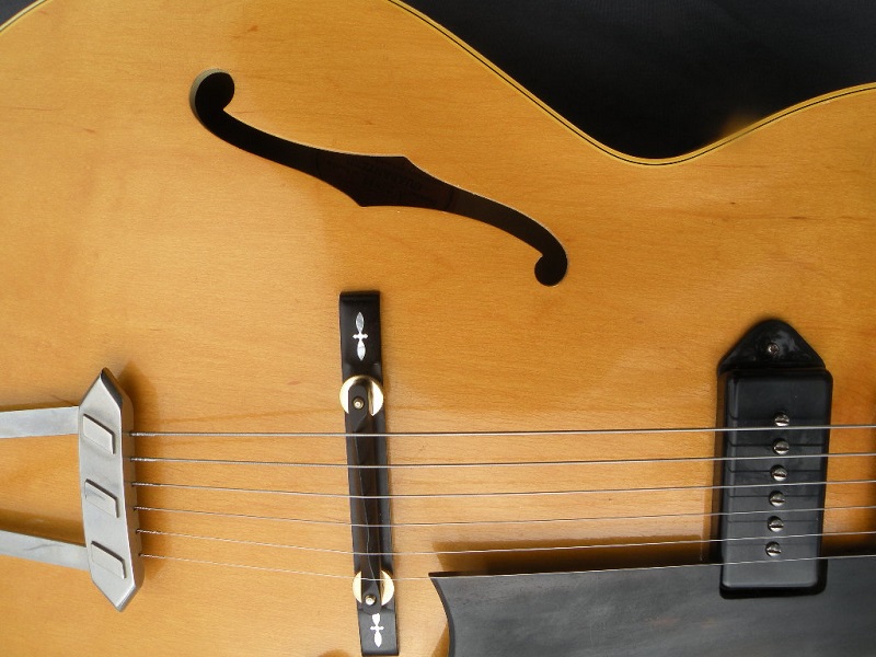    A close-up photo of  hollow body guitar.   