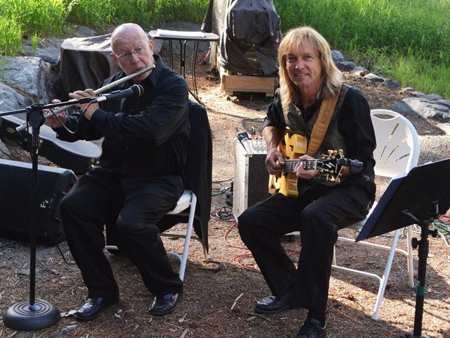    Bill Sickles performs on guitar with a flutist at a wedding ceremony in Golden Colorado.   